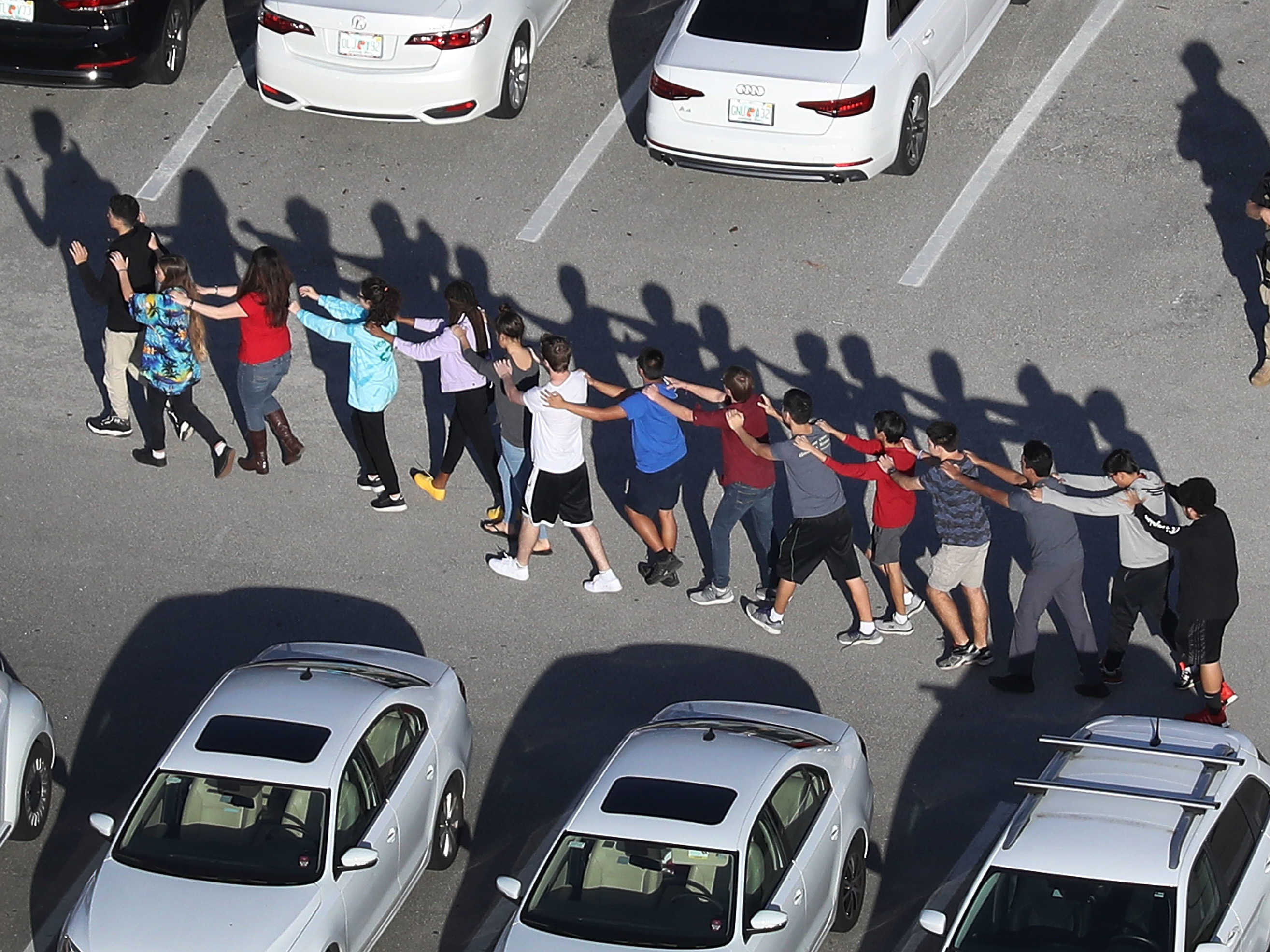 People are brought out of the Marjory Stoneman Douglas High School after a shooting at the school that killed and injured multiple people on Wednesday in Parkland, Fla. (Getty Images)