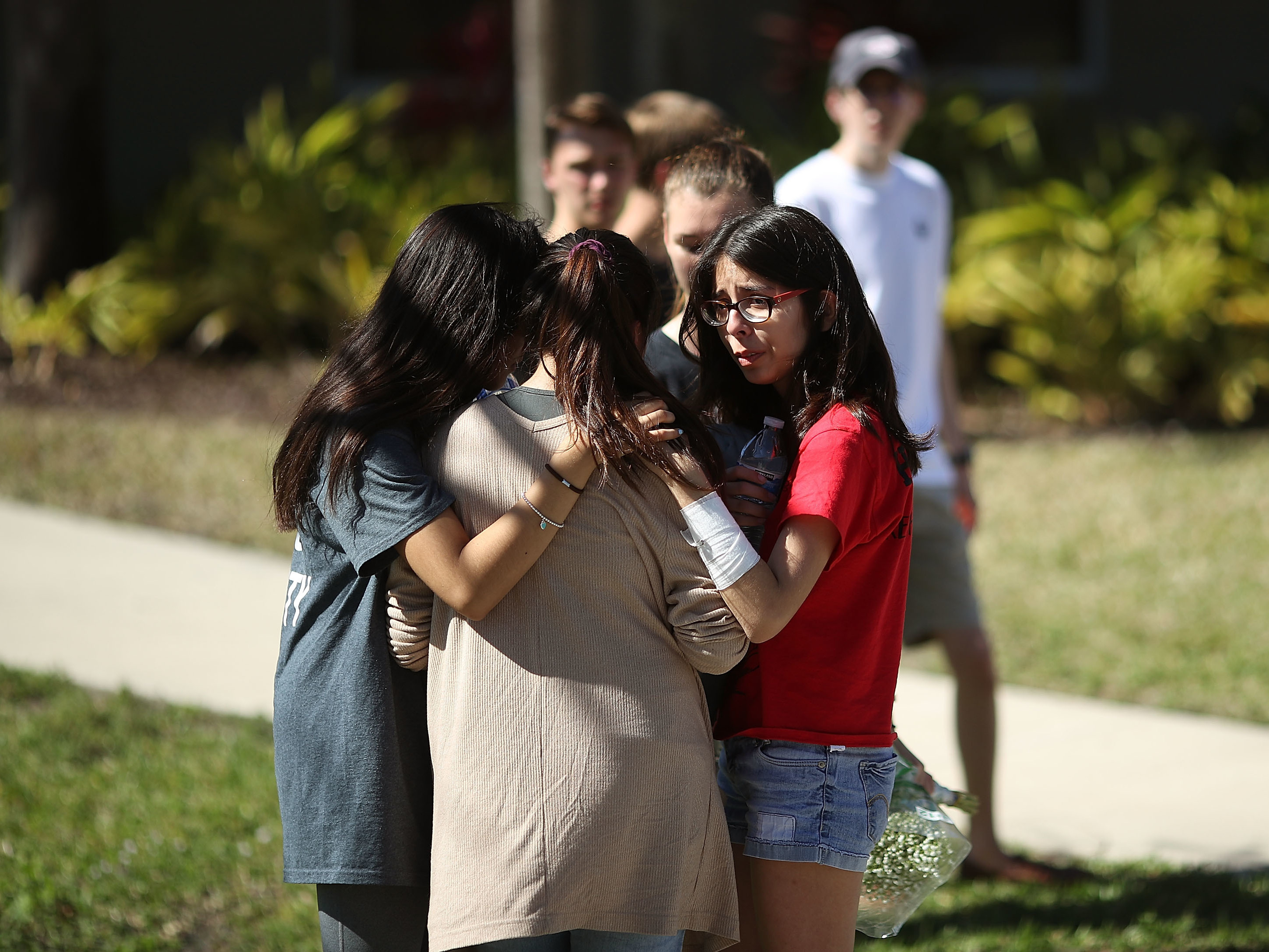 Students of Marjory Stoneman Douglas High School gather on Thursday in Parkland, Fla. Fourteen students and three staff members were killed in a shooting at the school on Wednesday. (Getty Images)