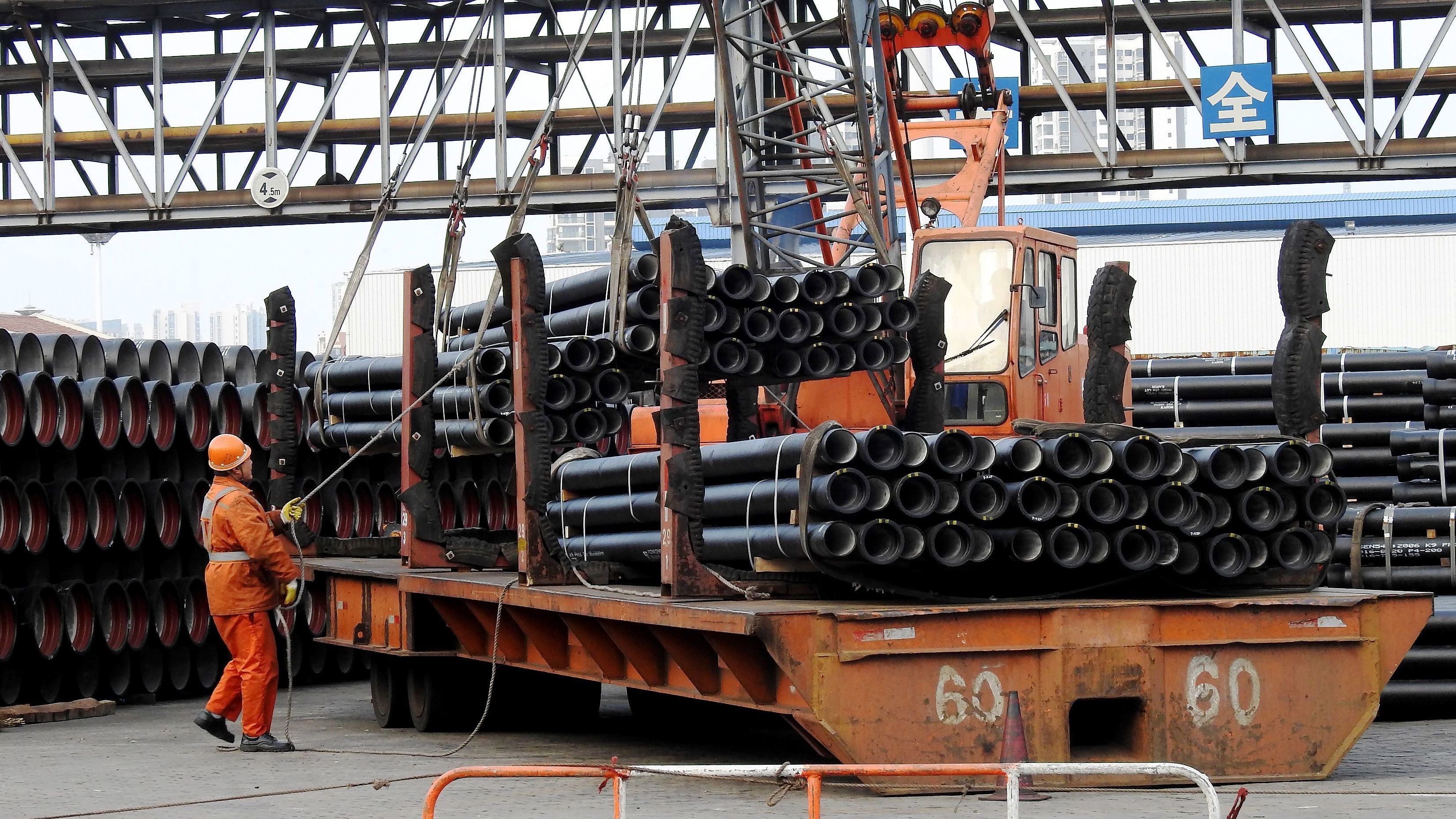 A Chinese worker loads steel tubes onto a truck in China's Jiangsu province in 2016. The Trump administration is considering imposing steep tariffs on imported steel and aluminum. (AFP/Getty Images)