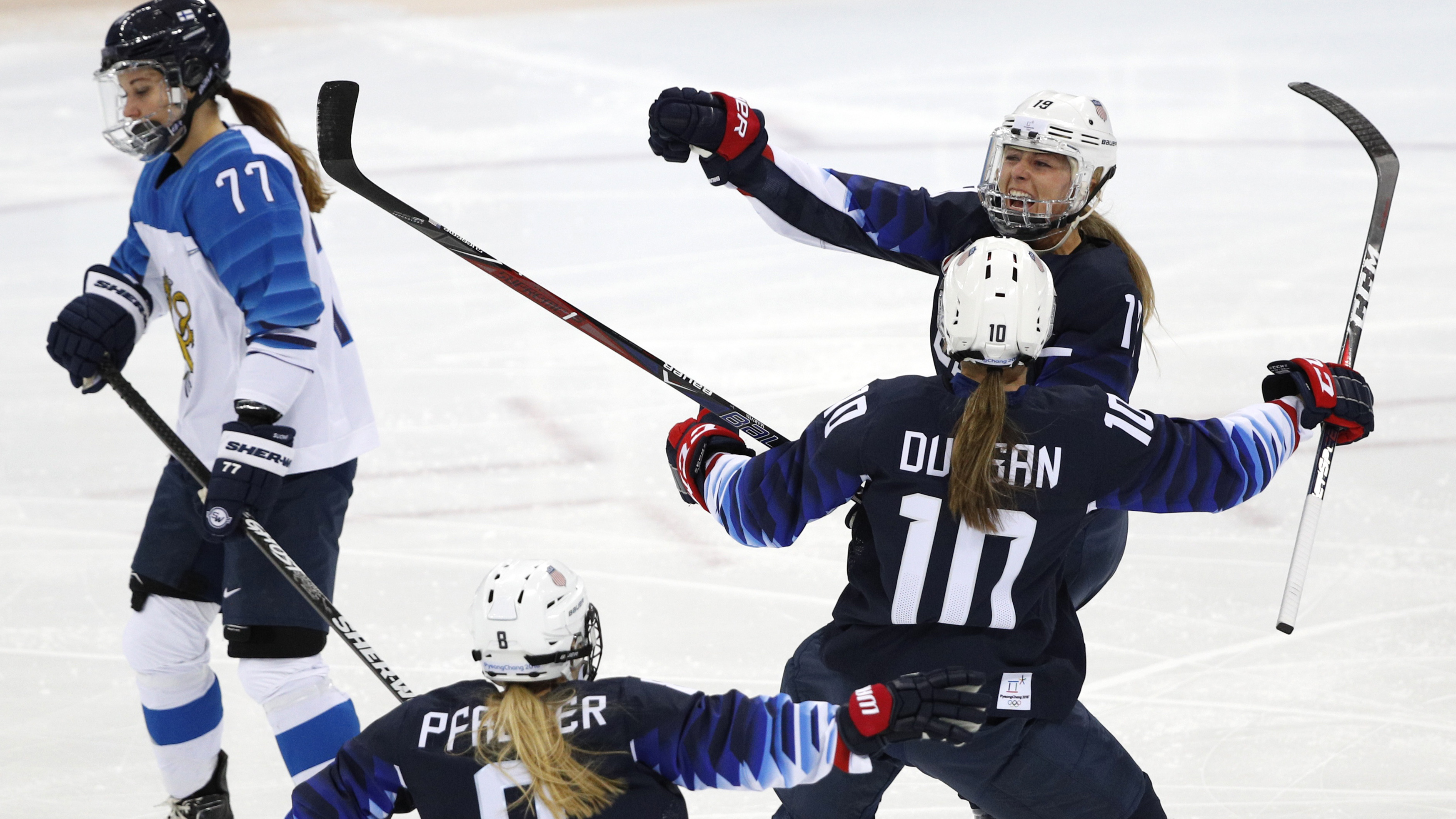 Gigi Marvin of the U.S., rear right, celebrates her goal in the first period of the women's semifinal match against Finland on Sunday. The victory sends the Americans to the gold medal match at the Pyeonghang Winter Olympics (Reuters)