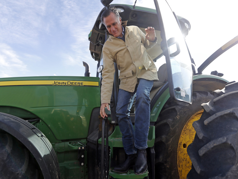 Former Republican presidential candidate Mitt Romney climbs down from a tractor during a tour of Gibson's Green Acres Dairy Friday, Feb. 16, in Ogden, Utah. Romney hopes to win the seat being vacated by retiring seven-term Utah Sen. Orrin Hatch. (Rick Bowmer/AP)
