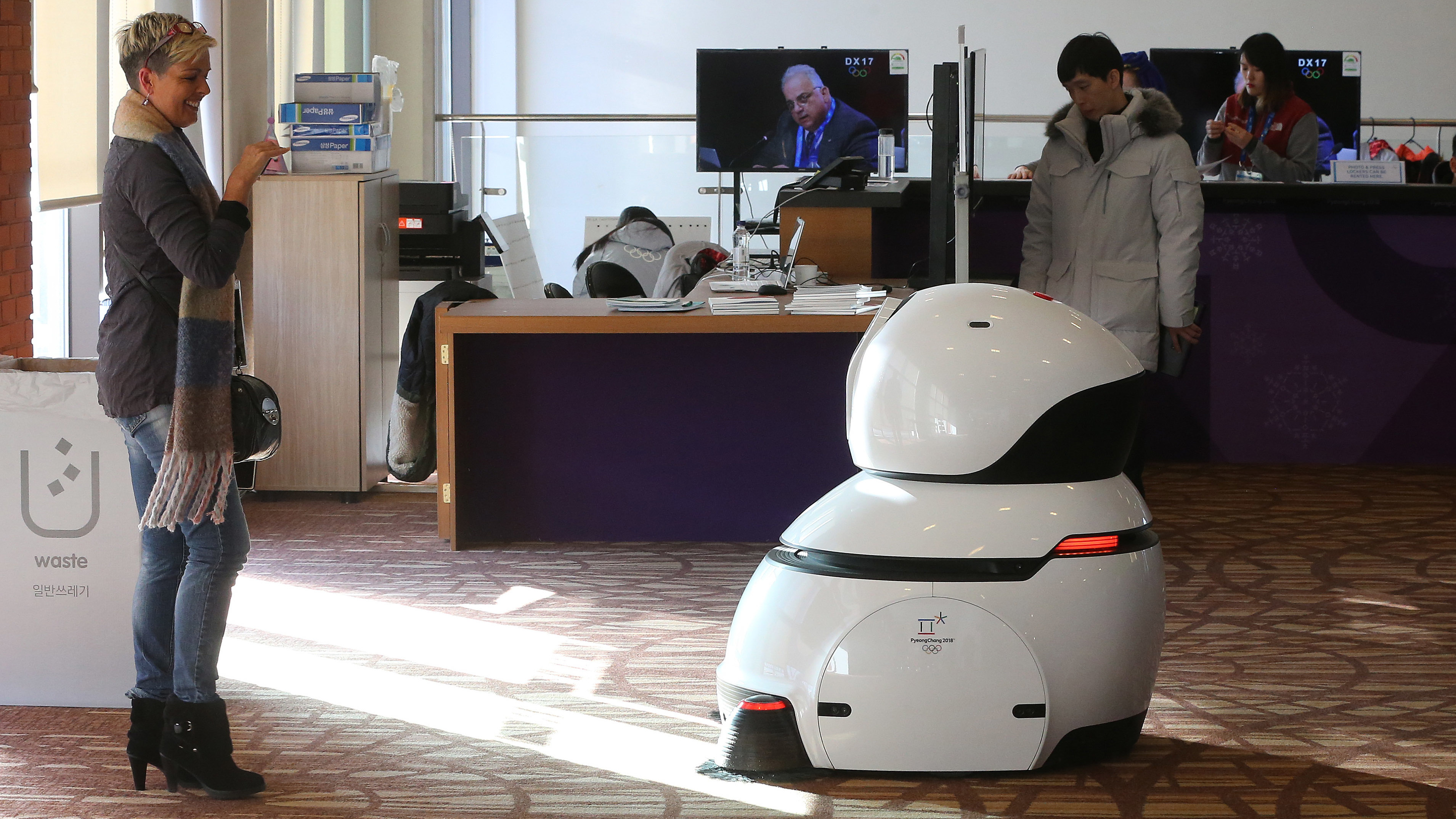 A robot sweeps the floor at the main press center at the Pyeonchang Winter Olympics.