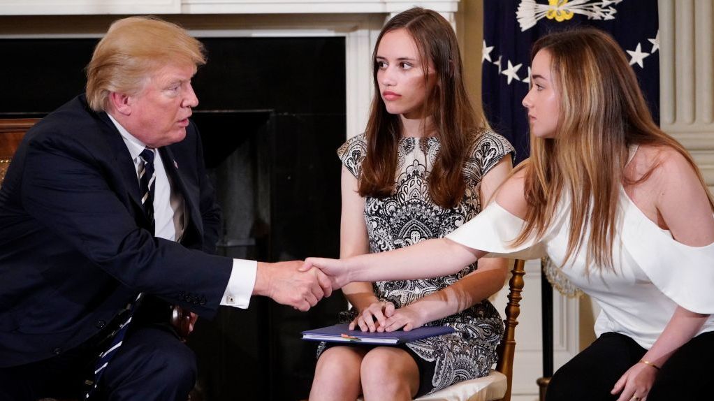 President Trump shakes hands with Marjory Stoneman Douglas High School student Ariana Klein as fellow Stoneman Douglas student Carson Abt watches at the start of a listening session on school safety with teachers and students at the White House Wednesday. (Getty Images)