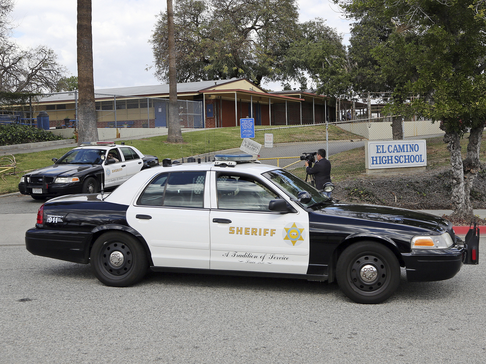 LA County Sheriff's patrol cars leave El Camino High School in Whittier, Calif., on Wednesday. A 17-year-old student threatened to open fire at the school days after the massacre at a Florida school. An alert security guard who overheard him reported it to police, who went to the boy's home and found two AR-15 rifles, authorities said Wednesday.