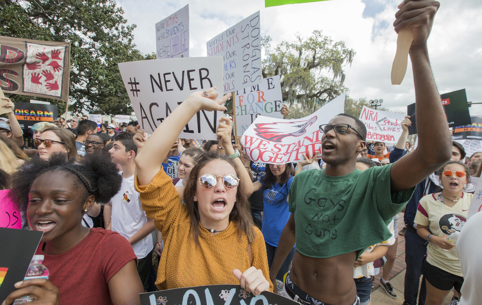 Therese Gachnauer, center, an 18-year-old senior from Chiles High School and Kwane Gatlin, right, a 19-year-old senior from Lincoln High School, both in Tallahassee, join fellow students protesting gun violence on the steps of the old Florida Capitol in Tallahassee, Fla. (Mark Wallheiser/AP)