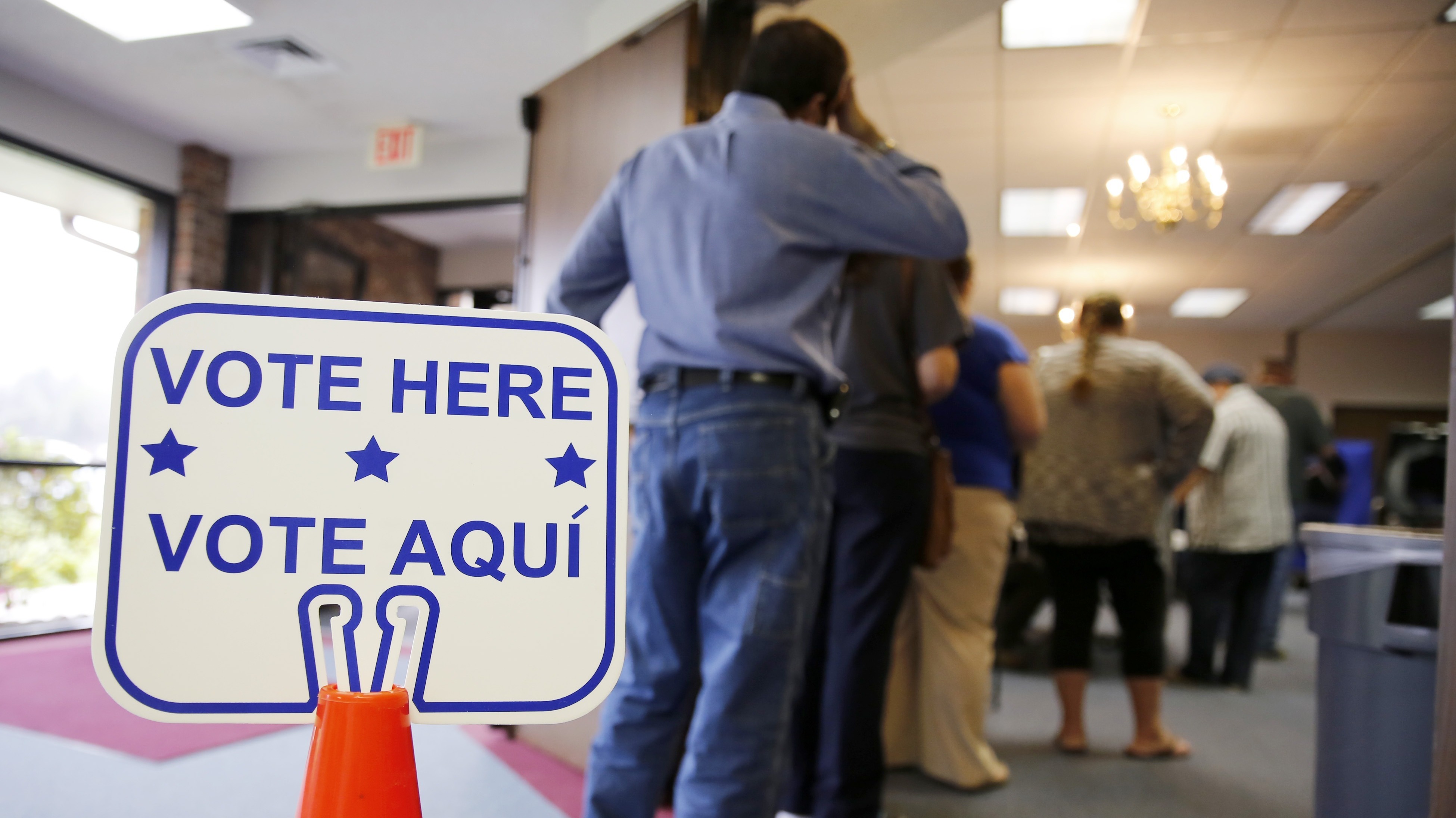 Voters stand in line to cast their ballots inside Calvary Baptist Church March 1, 2016, in Rosenberg, Texas.