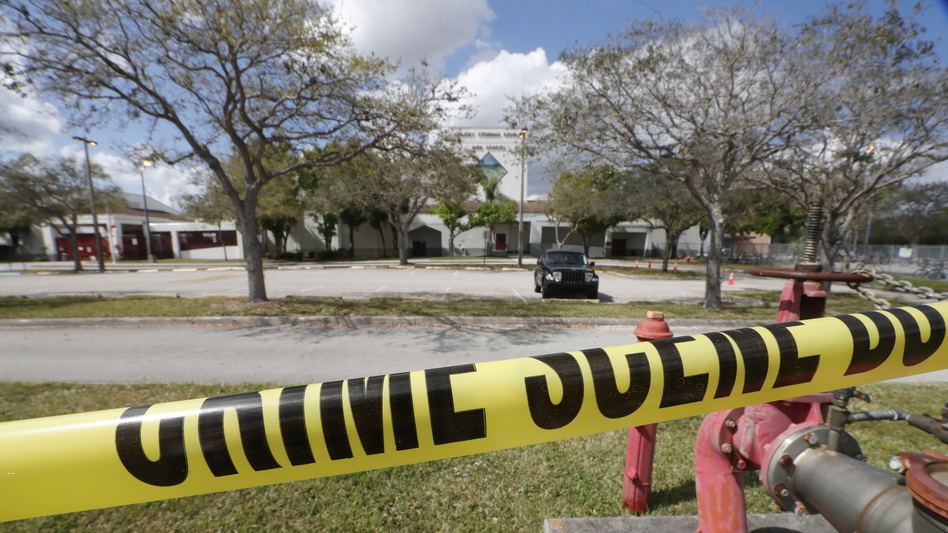 Crime scene tape runs outside Marjory Stoneman Douglas High School in Parkland, Fla., on Sunday, Feb. 18., a few days after the shooting that left 17 people dead. (Gerald Herbert/AP)
