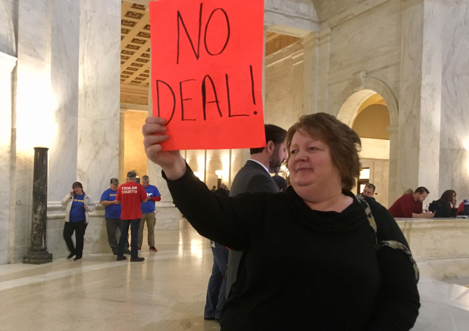 Special needs teacher's aide Belva Perry holds up a sign on Wednesday at West Virginia's Capitol that reads "no deal." (John Raby/AP)