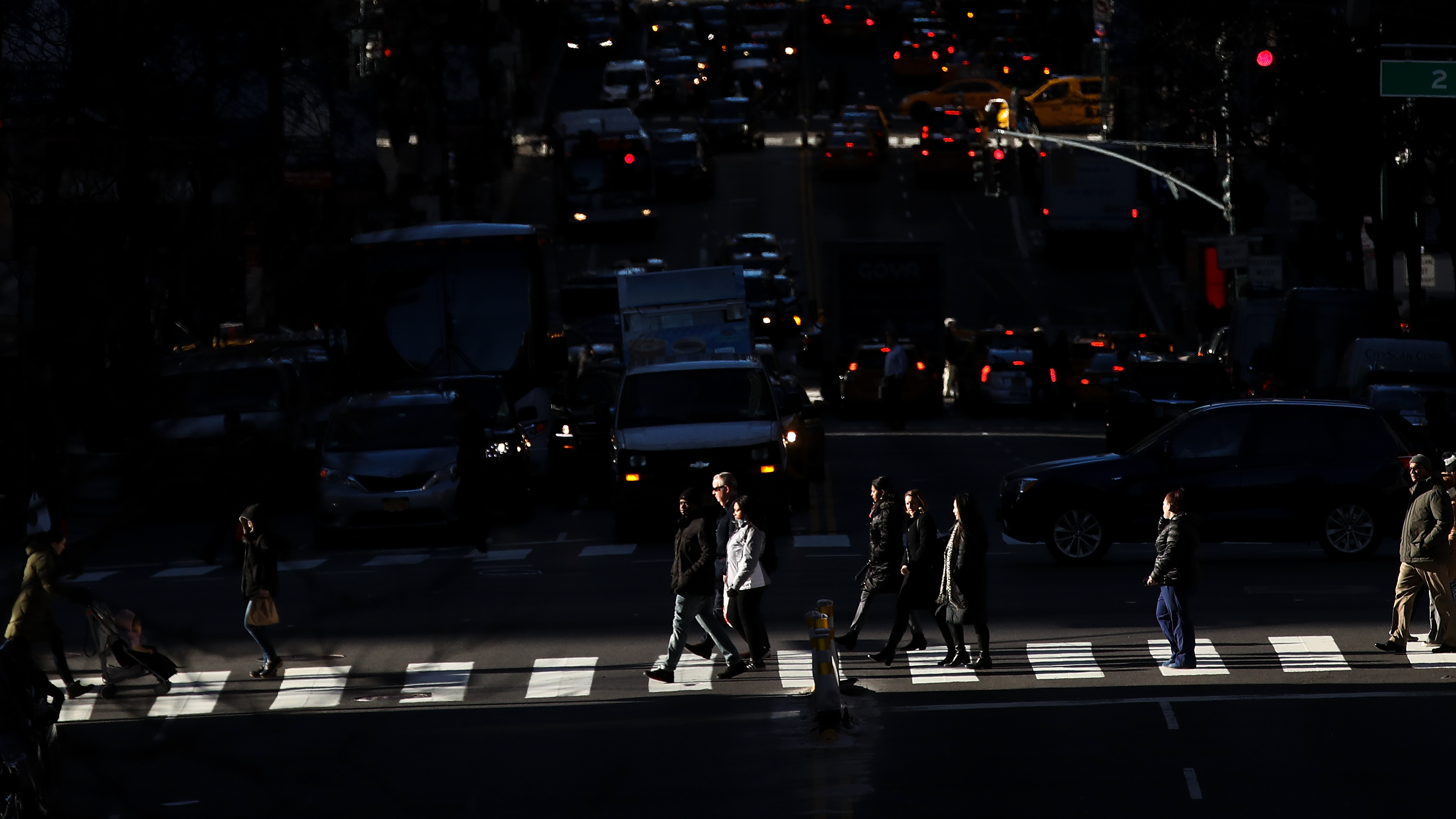 Pedestrians cross the street as traffic moves along 42nd Street in Midtown Manhattan on Jan. 25. (Getty Images)