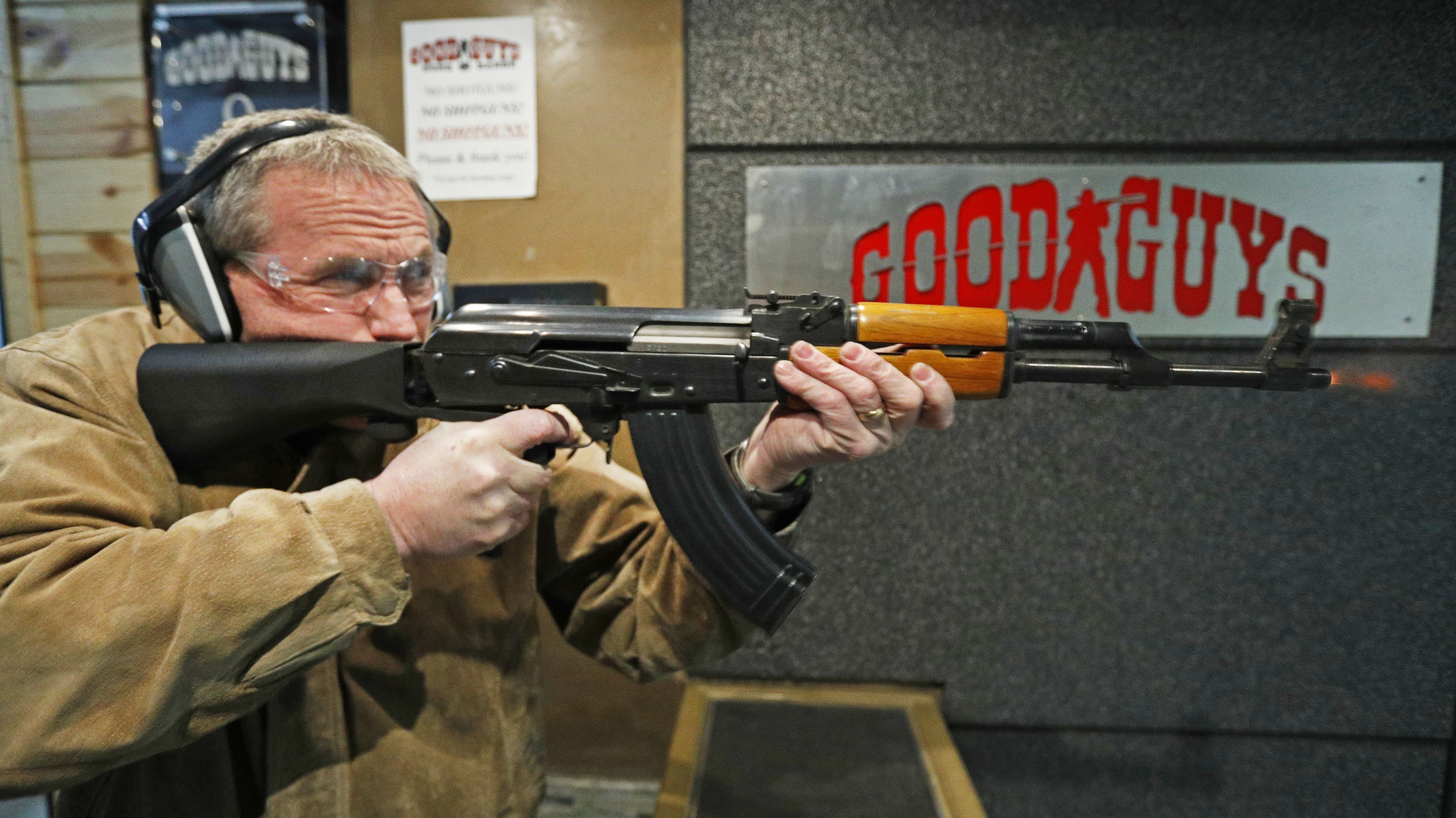 Vince Warner fires an AK-47 with a bump stock installed at Good Guys Gun and Range in Utah. A significant majority of Americans favor outlawing the attachment, according to the latest NPR/Ipsos poll. (Getty Images)