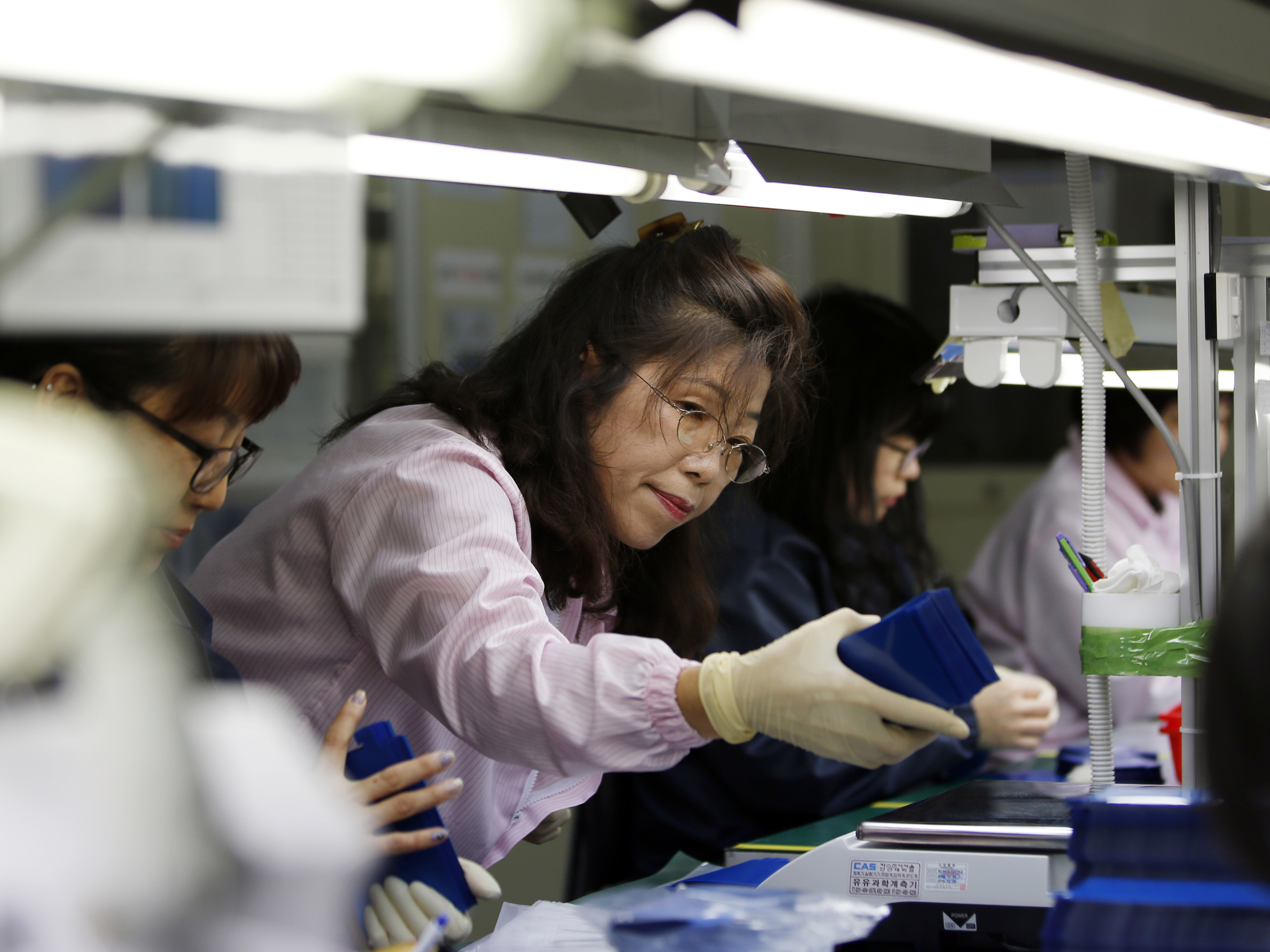 South Korea's parliament has shortened the maximum workweek amid the country's low birth and productivity rates. Workers are seen here at a factory in Ansan, South Korea, in 2015. (Reuters)