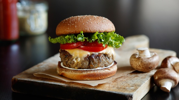 A classic blended beef-mushroom burger. The idea is that mixing chopped mushrooms into our burgers boosts the umami taste, adds more moisture, and reduces the amount of beef required for a burger. And reducing the need for beef has a big impact on the environment. This type of burger will soon debut on menus at fast-food chain Sonic Drive-In.