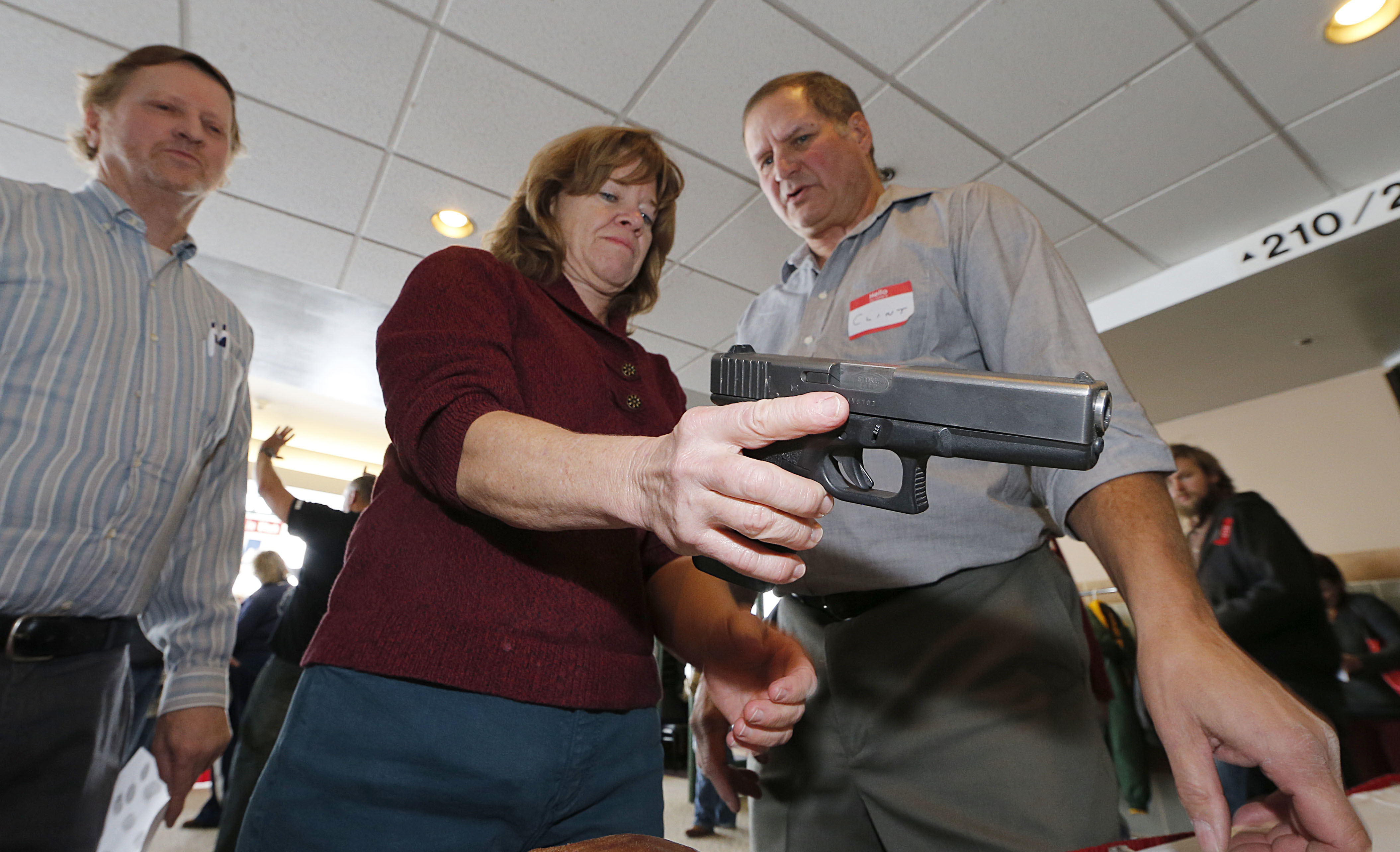 A Utah teacher is shown how to handle a handgun by instructor Clint Simon (right) at a concealed-weapons training class to 200 Utah teachers in 2012.