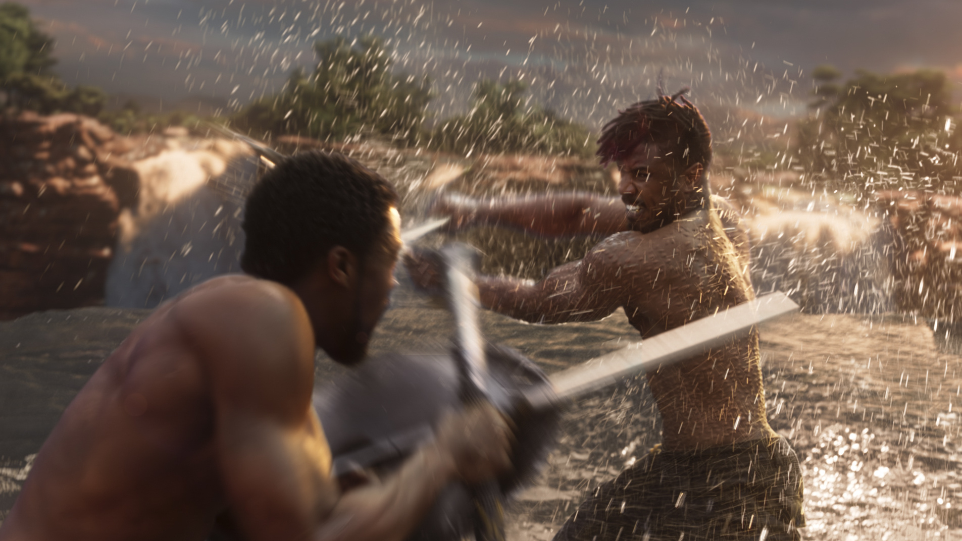 Black Panther (Chadwick Boseman), left, and Erik Killmonger (Michael B. Jordan) battle it out in a fight fueled by dueling visions of resource management.