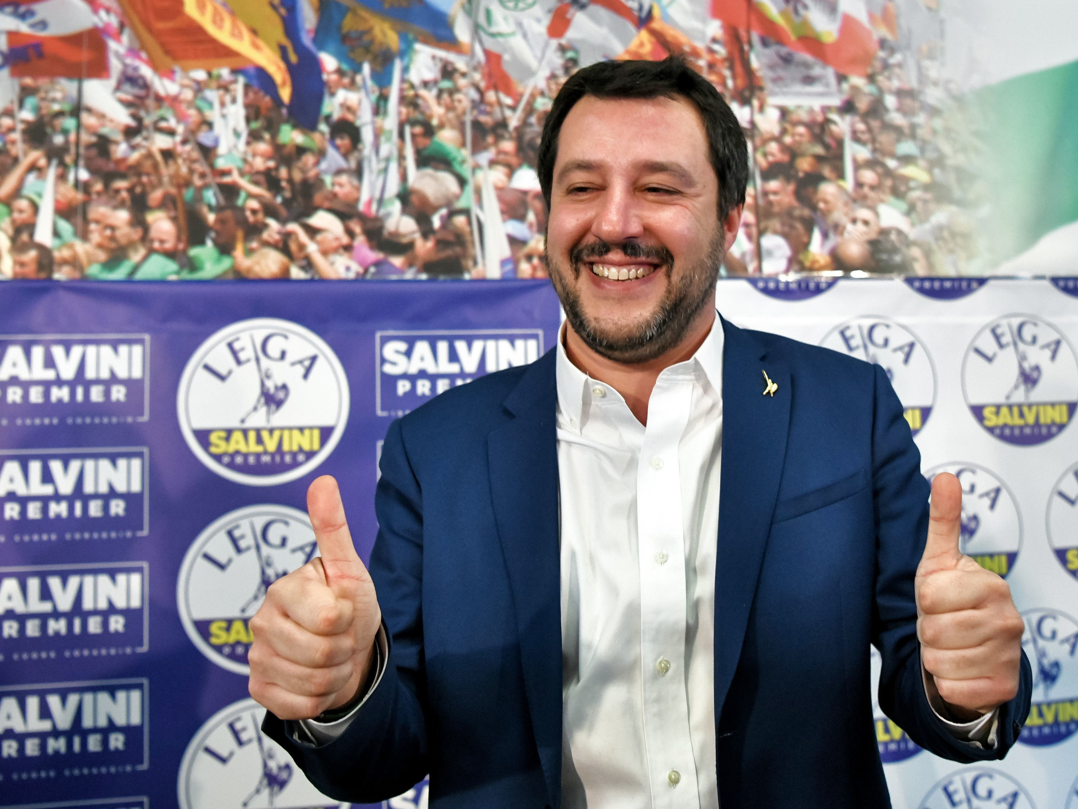 Italian far-right League party leader Matteo Salvini gives the thumbs-up in Milan on Monday. Salvini said his right-wing coalition had the &quot;right and the duty&quot; to form a government after taking 37 percent of the vote in the weekend election. (AFP/Getty Images)