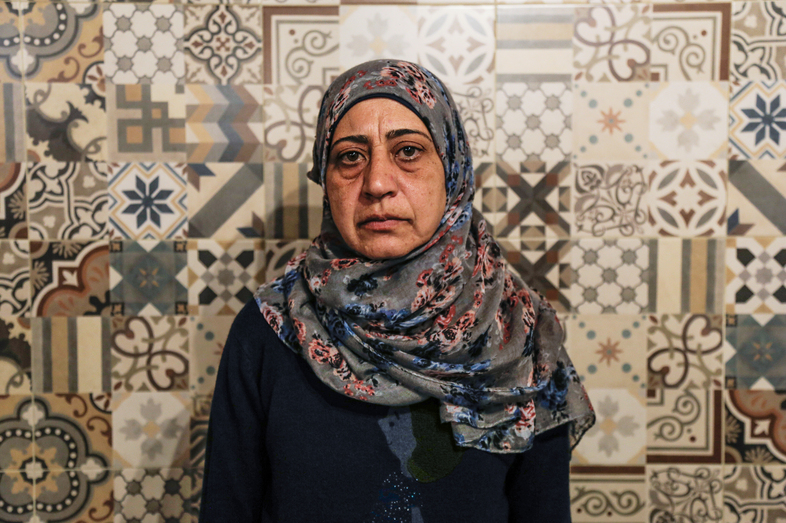 Amal Adwan, a 47-year-old teacher from Damascus, Syria, must stay on Lesbos until she exhausts all appeals for her asylum request, which was denied on the basis that Turkey is a safe country. "Syrians face discrimination in Turkey," she says. "We cannot find work, and if we do, they don't pay us." (Daphne Tolis for NPR)