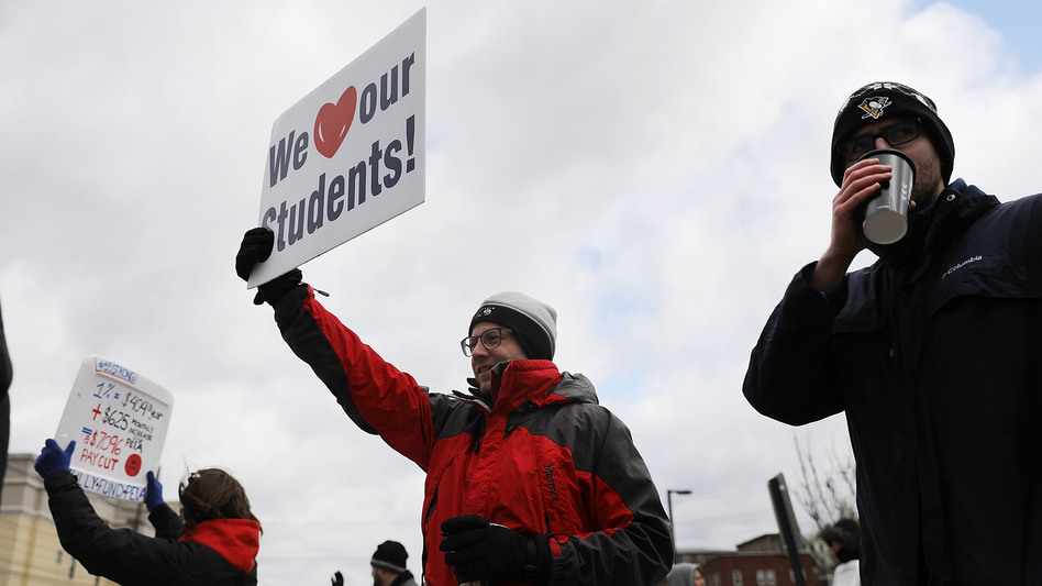 West Virginia teachers, students and supporters hold their signs aloft during a demonstration earlier this month in Morgantown, W.Va. (Spencer Platt/Getty Images)