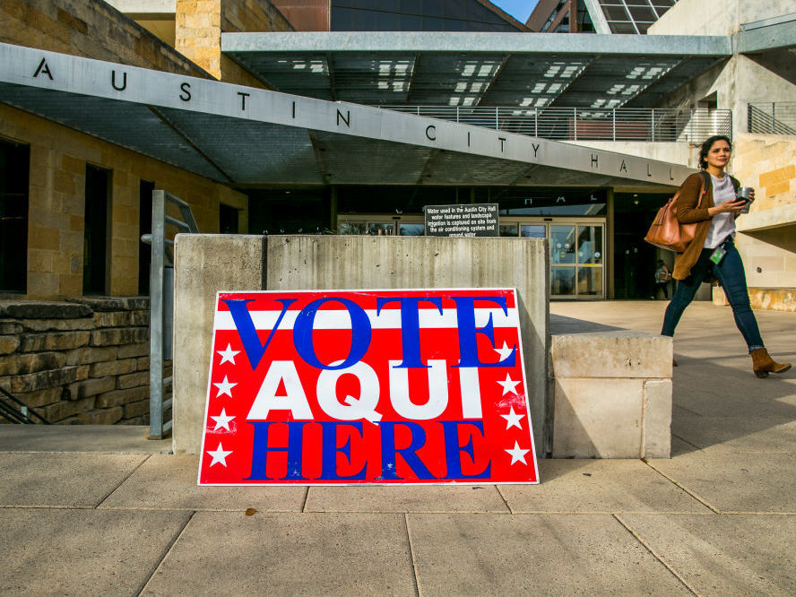 A pedestrian walks past Austin City Hall, an early voting center, on Tuesday in Austin, Texas. (Getty Images)