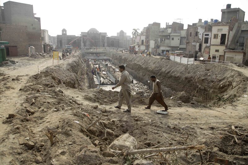Men walk past the trench Men walk past the trench
