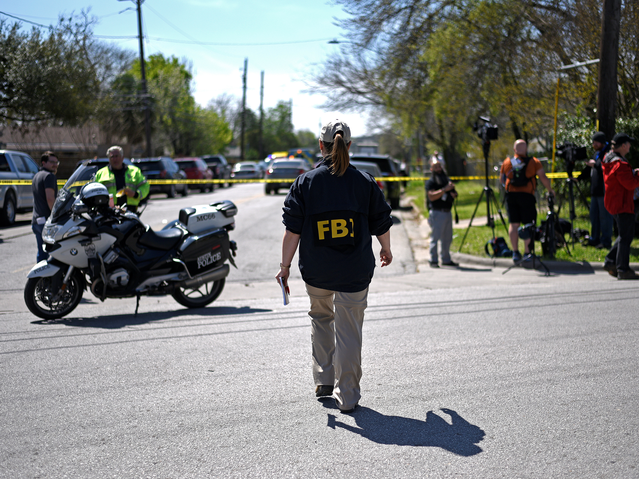 An FBI agent walks toward the scene of one of the blasts in Austin on Monday. (Reuters)