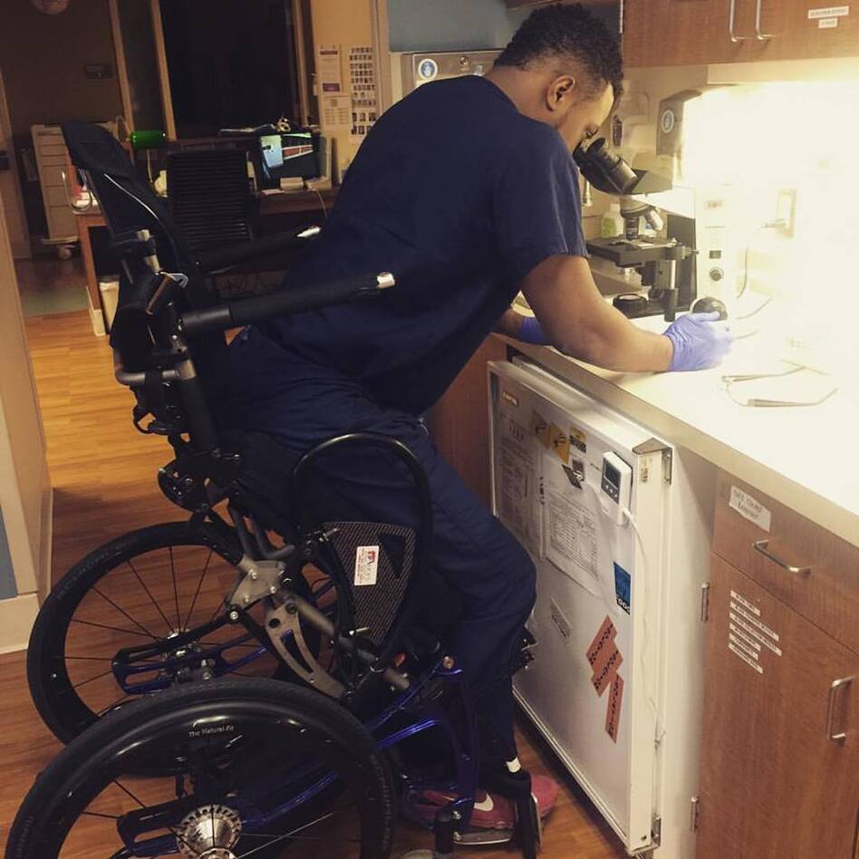 Feranmi Okanlami, now a doctor, became partially paralyzed after an accident in 2013. He says adjustments for his disability during his training, like this chair that lets him stand, helped him succeed. A new report finds variability in medical institution culture and protocols when it comes to supporting aspiring doctors with disabilities. (Courtesy of Feranmi Okanlami)