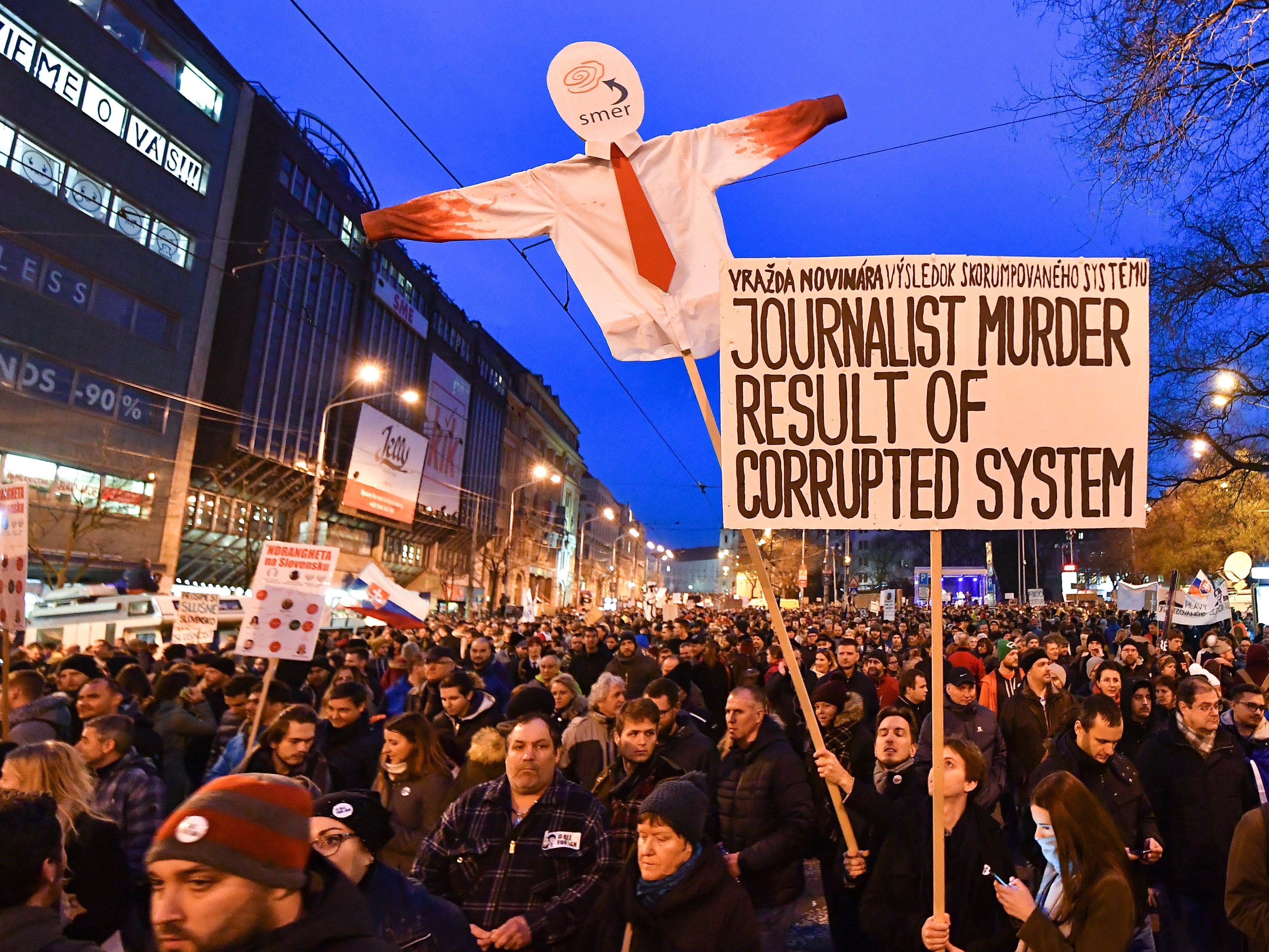 Protesters holds placards during a rally last week to pay tribute to murdered Slovak journalist Jan Kuciak and his fiancee Martina Kusnirova at the Slovak National Uprising (SNP) square in Bratislava. (AFP/Getty Images)