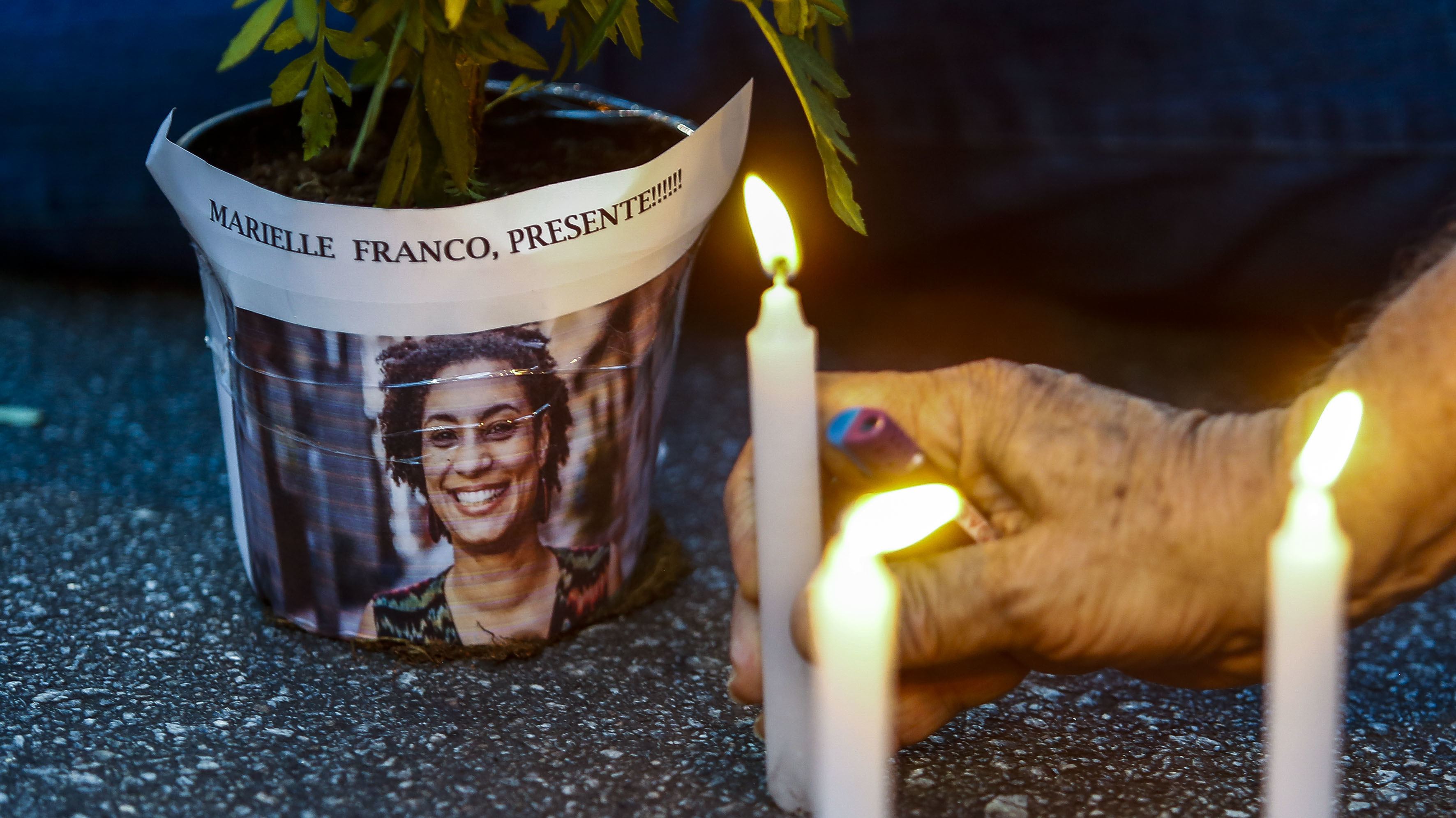 An elderly man lights a candle during a rally against the murder of Brazilian councilwoman and activist Marielle Franco, in Sao Paulo Brazil on March 15, 2018. Brazilians mourned for the Rio de Janeiro councilwoman and outspoken critic of police brutality who was shot in the city center in an assassination-style killing. (AFP/Getty Images)