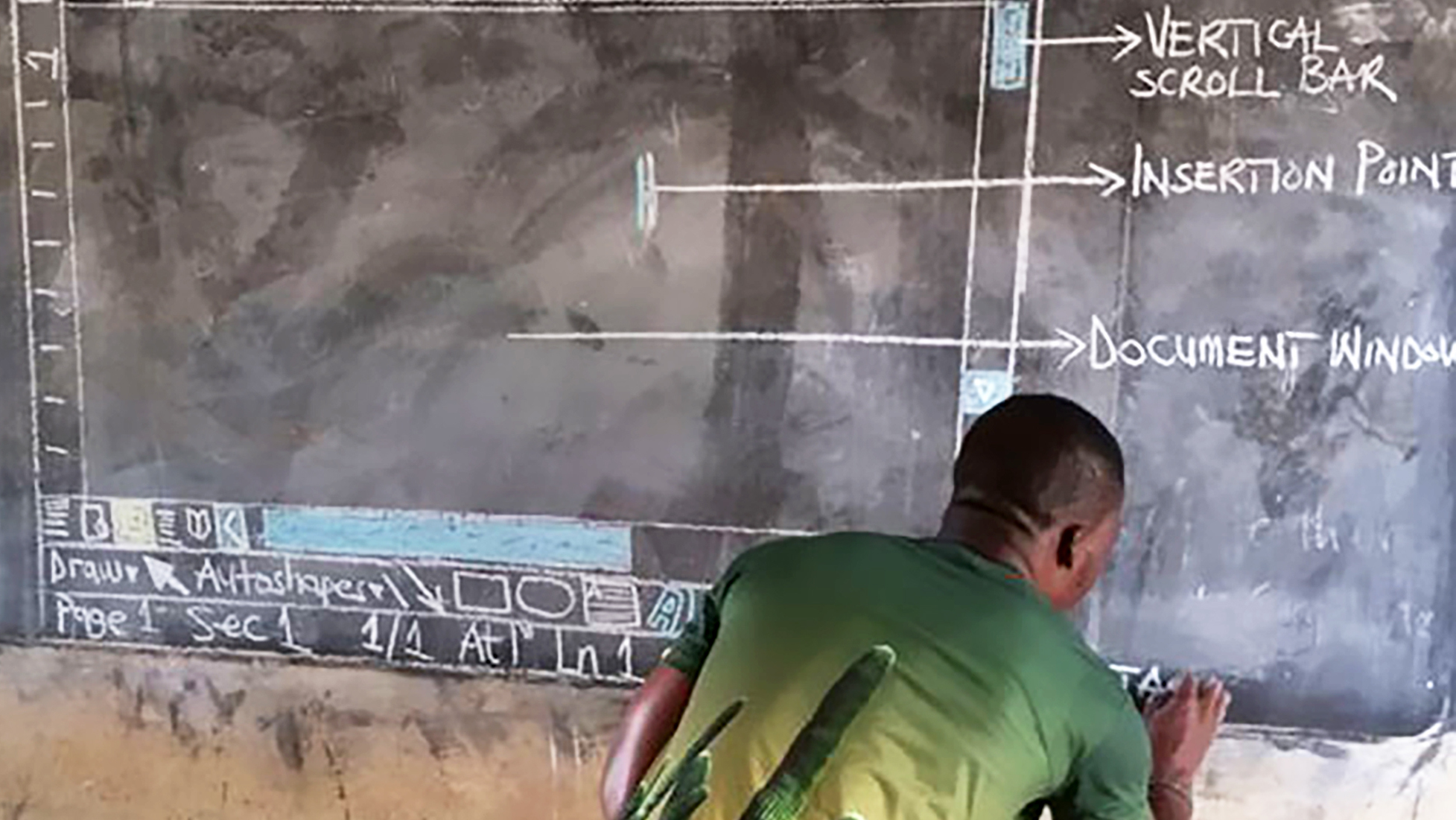 Owura Kwadwo Hottish illustrates a window of Microsoft Word using colored chalk on a blackboard for his students at the Betenase M/A Junior High School in Kumasi, Ghana.