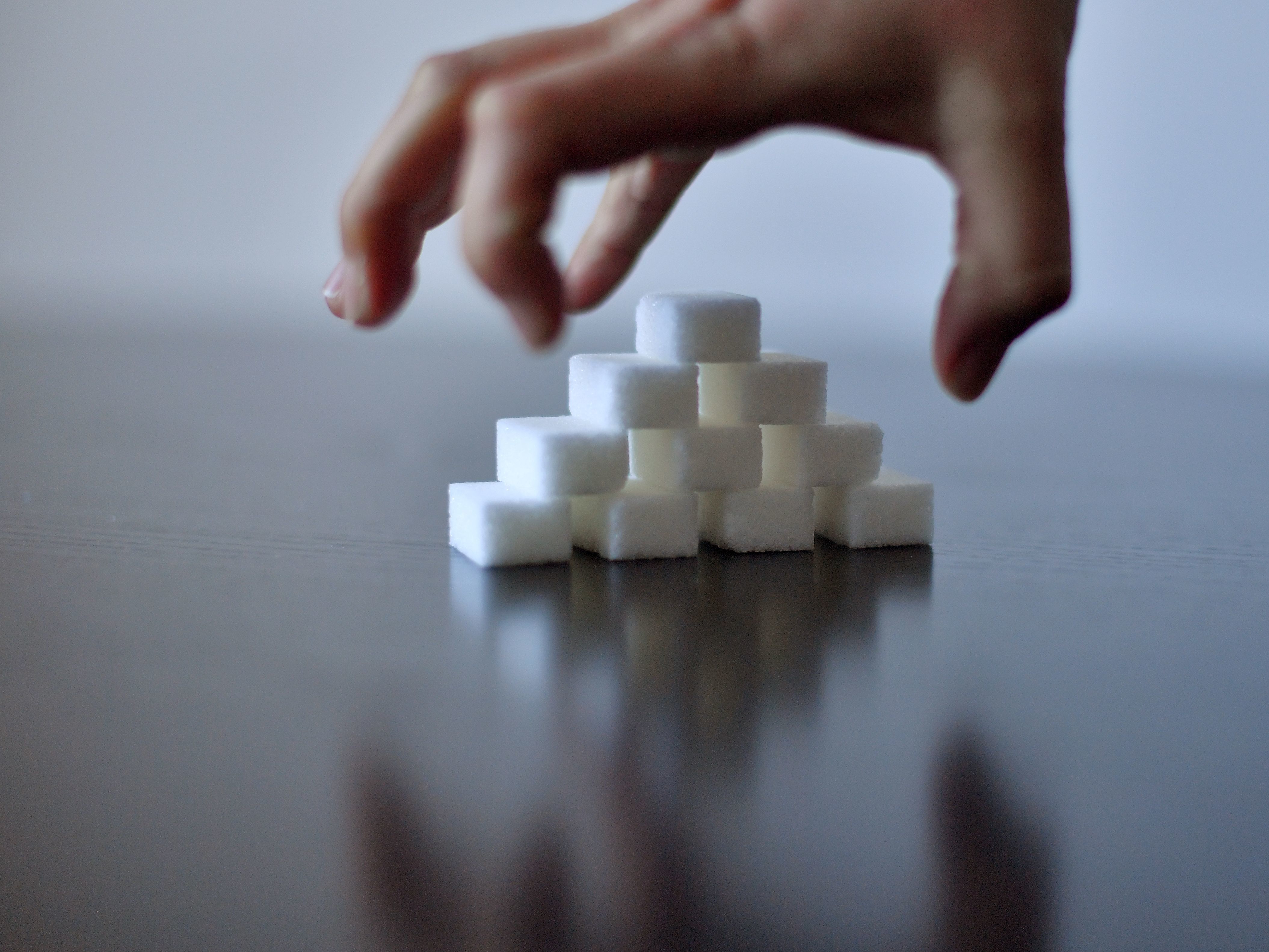 A girl's hand reaches for sugar cubes. &quot;We told people to load up on processed carbohydrates and gave sugary beverages a pass,&quot; said Dr. David Ludwig on what science got wrong about childhood obesity. (AFP/Getty Images)