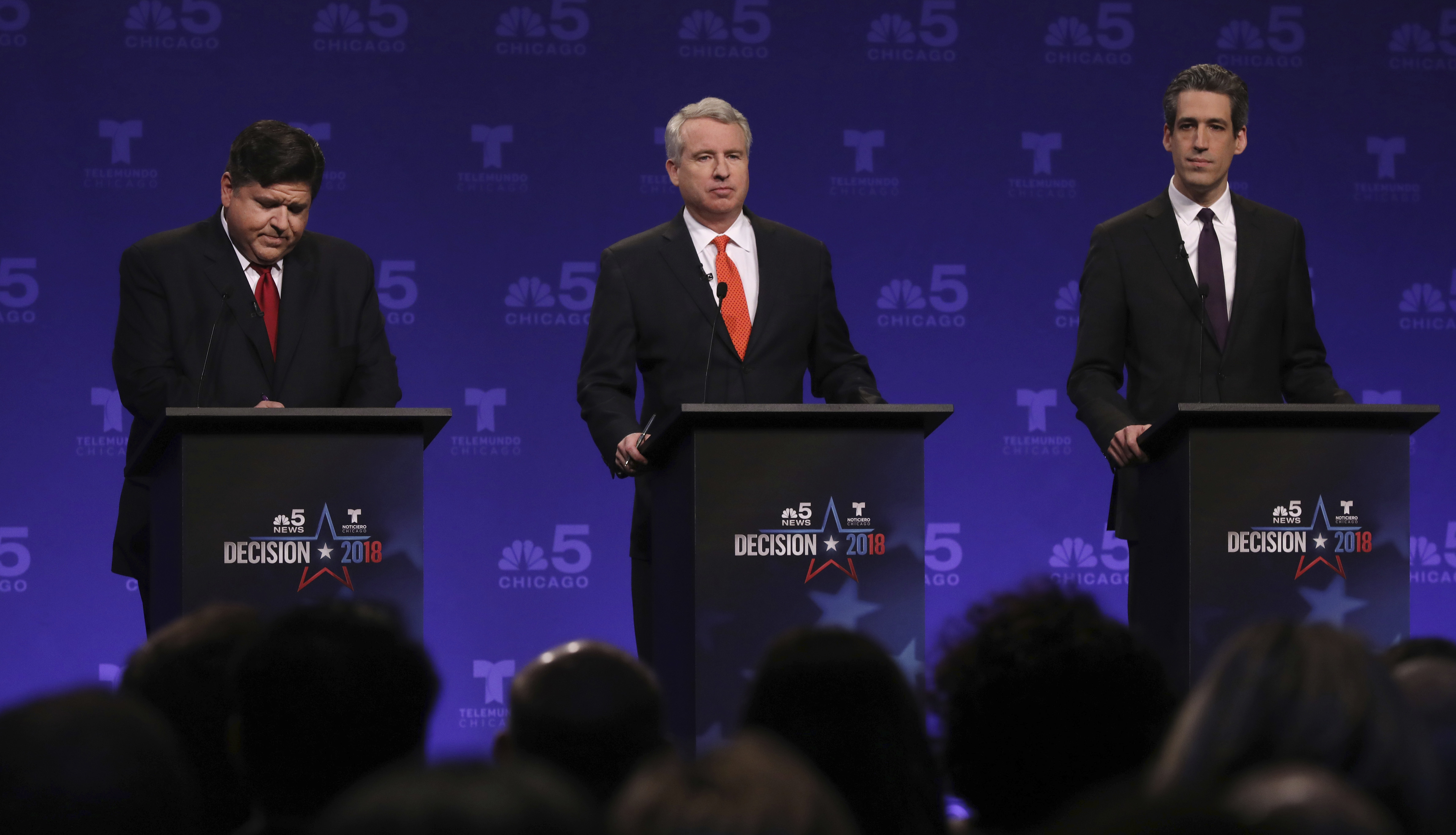 Democrats running for Illinois governor from left, billionaire J.B. Pritzker, businessman Chris Kennedy, and state Sen. Daniel Biss take their podium positions before a televised forum in January. (John J. Kim/AP)