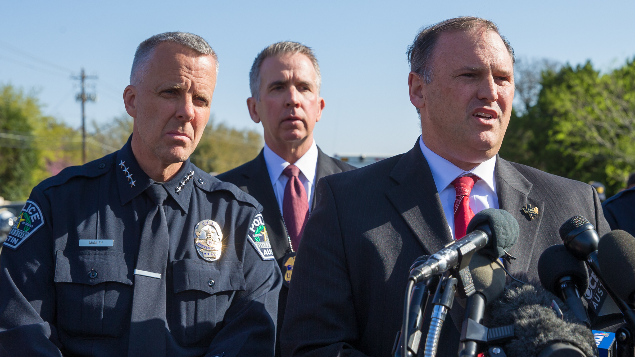 Austin Police Chief Brian Manley (from left), ATF Special Agent in Charge Fred Milanowski and FBI Special Agent in Charge Christopher Combs at a news conference on Monday in Austin, Texas. They said a bomb that exploded Sunday night appeared to have used a tripwire. (AFP/Getty Images)