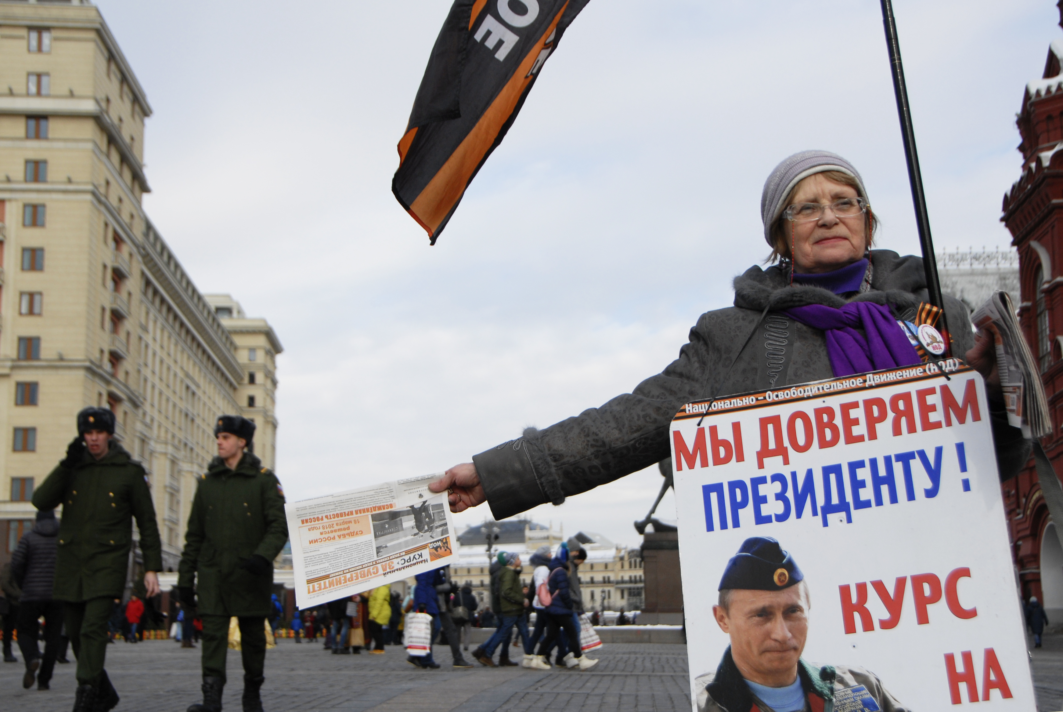 A supporter of Russian President Vladimir Putin campaigns for him in Red Square in central Moscow. (NPR)