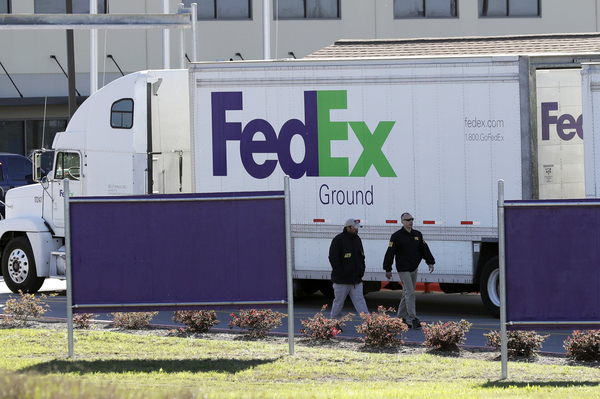 Agents from the Bureau of Alcohol, Tobacco, Firearms and Explosives join the investigation at a FedEx distribution center in Schertz, Texas, where a package exploded Tuesday. Authorities believe the incident is linked to the recent string of Austin bombings.
