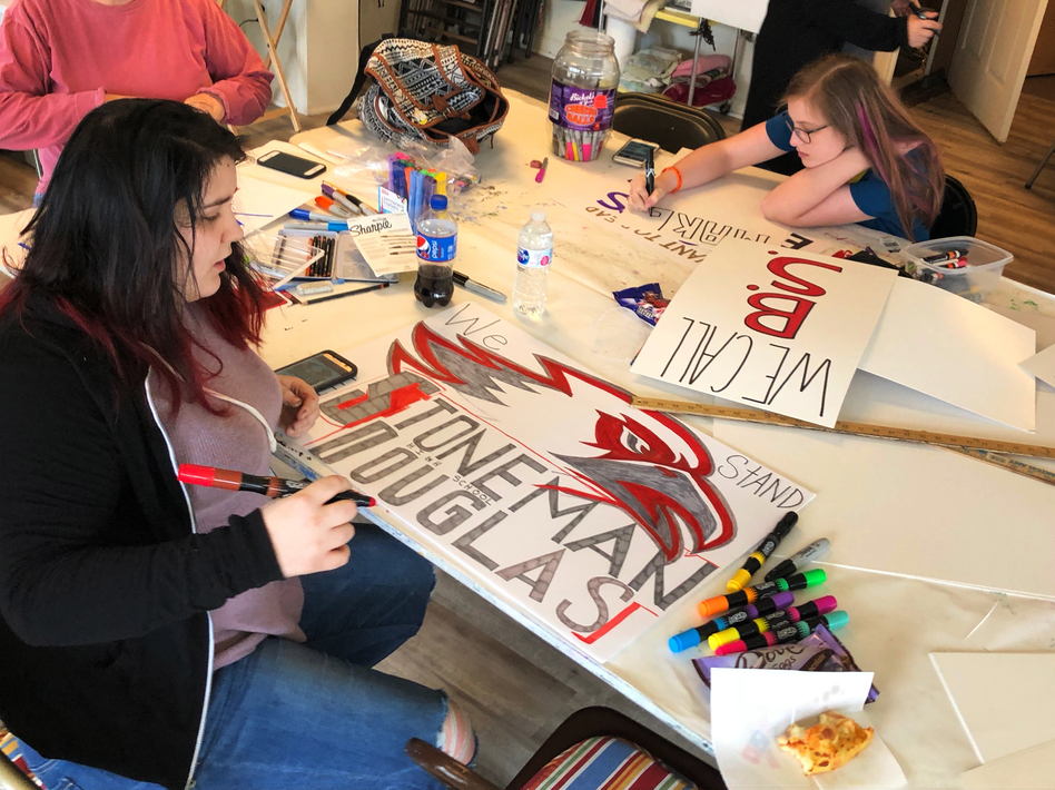 On March 18, Marshall County High School freshman Lela Free (left) works on a sign for the March for our Lives rally her community is planning for this Saturday. Free survived a shooting at her school in January, but was moved to action by the shooting in Parkland, Fla., on Feb. 14. (Camila Domonoske/NPR)