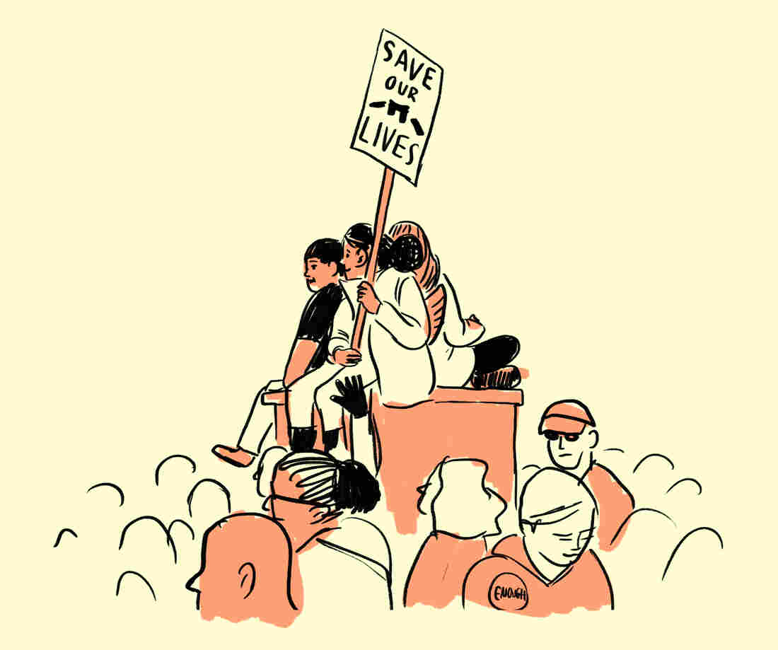 Kids sit atop an electrical box above the crowd.