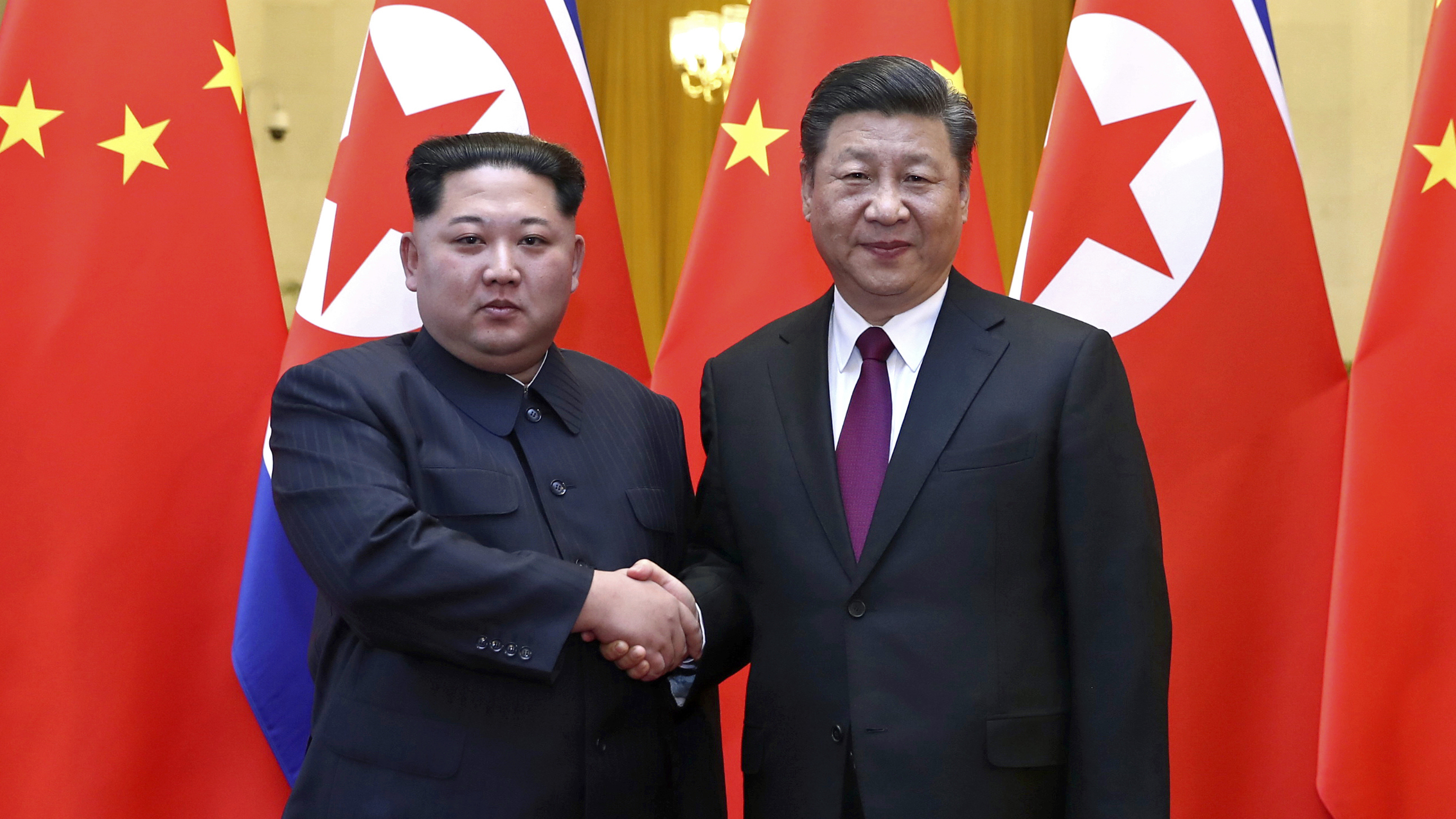 North Korean leader Kim Jong Un and Chinese President Xi Jinping shake hands in Beijing, in this photo provided by China's Xinhua News Agency in Beijing. Kim was making his first known trip to a foreign country since he took power in 2011.