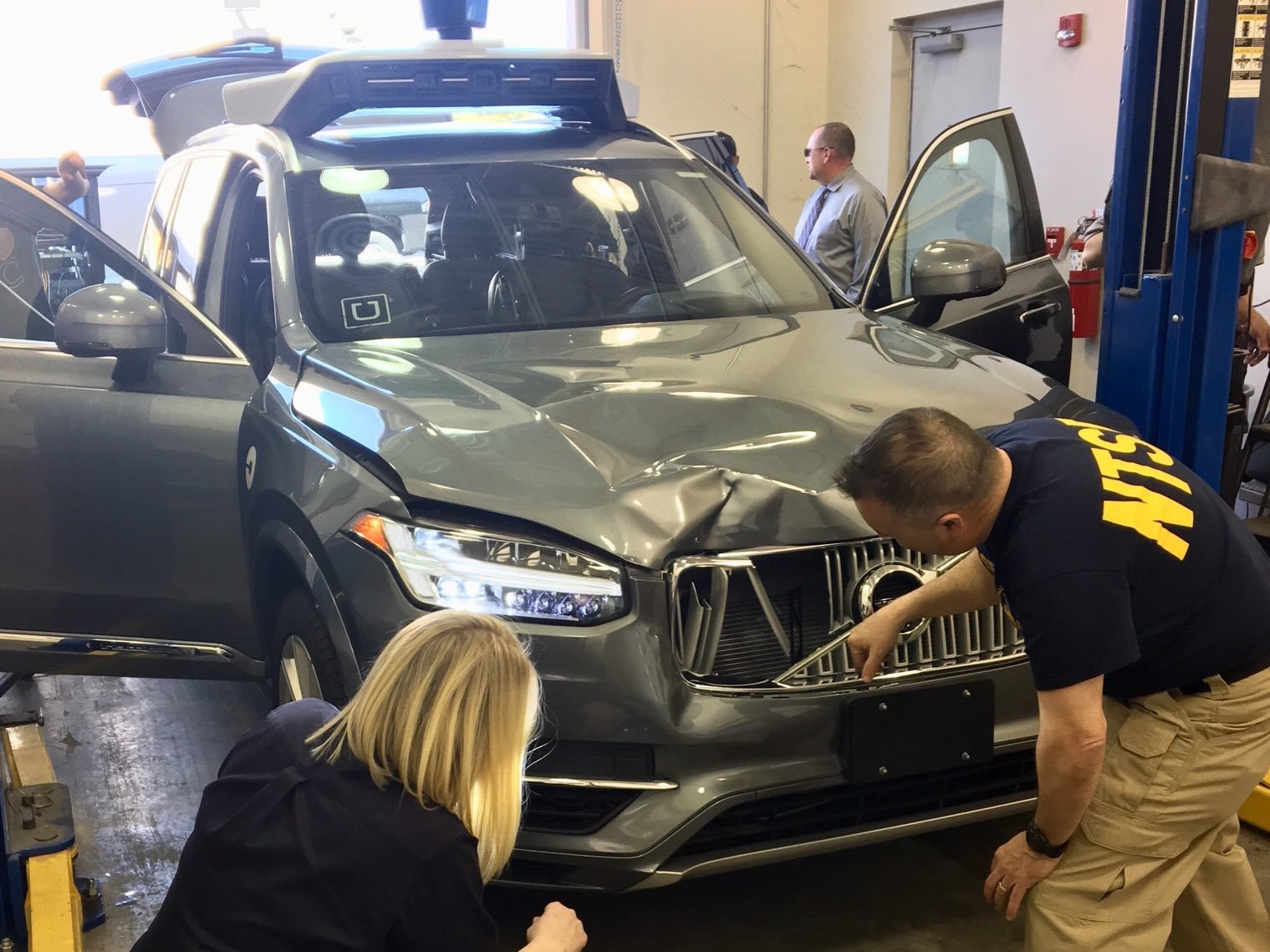 Investigators for the National Transportation Safety Board in Tempe, Ariz., examine the Uber vehicle involved in the fatal crash. (NTSB/Twitter)