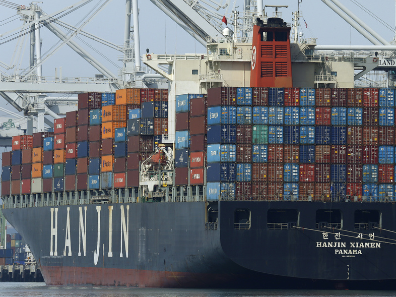 A container ship waits to be unloaded at the Port of Oakland in California. President Trump says the trade deficit that the U.S. runs with other nations must be slashed for the well-being of the country. (Ben Margot/AP)