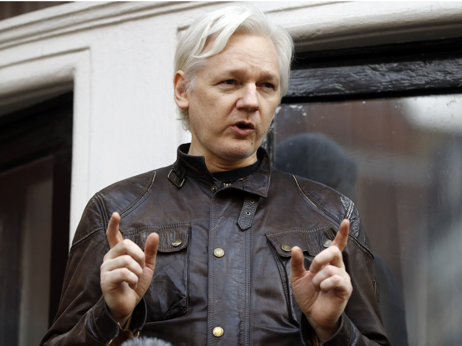 WikiLeaks founder Julian Assange talks to supporters outside the Ecuadorean Embassy in London, where he has been in self-imposed exile since 2012. (Frank Augstein/AP)