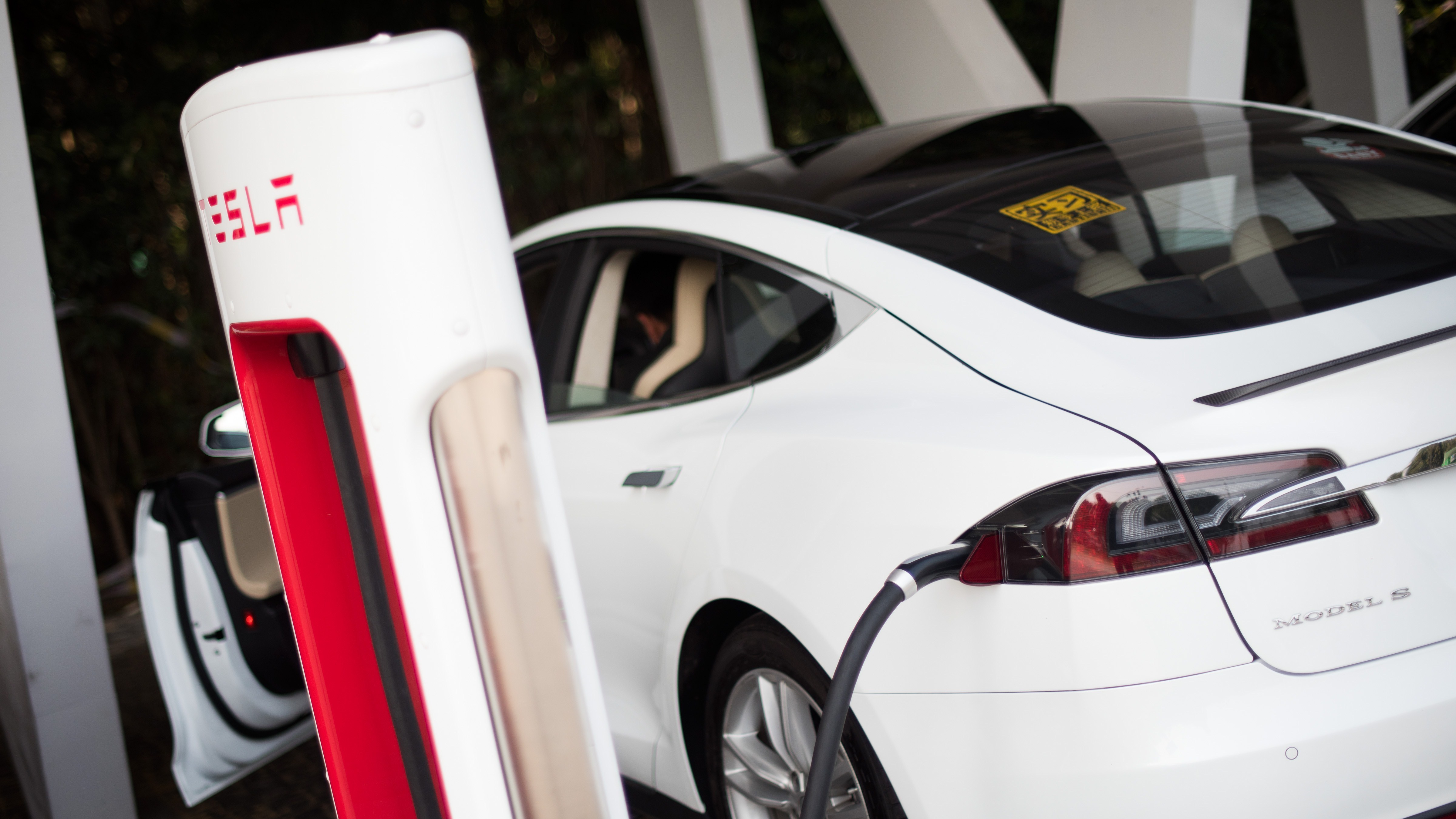 A Tesla Model S electric vehicle is charged at a car dealership in Shanghai, China, in March 2015. (AFP/Getty Images)
