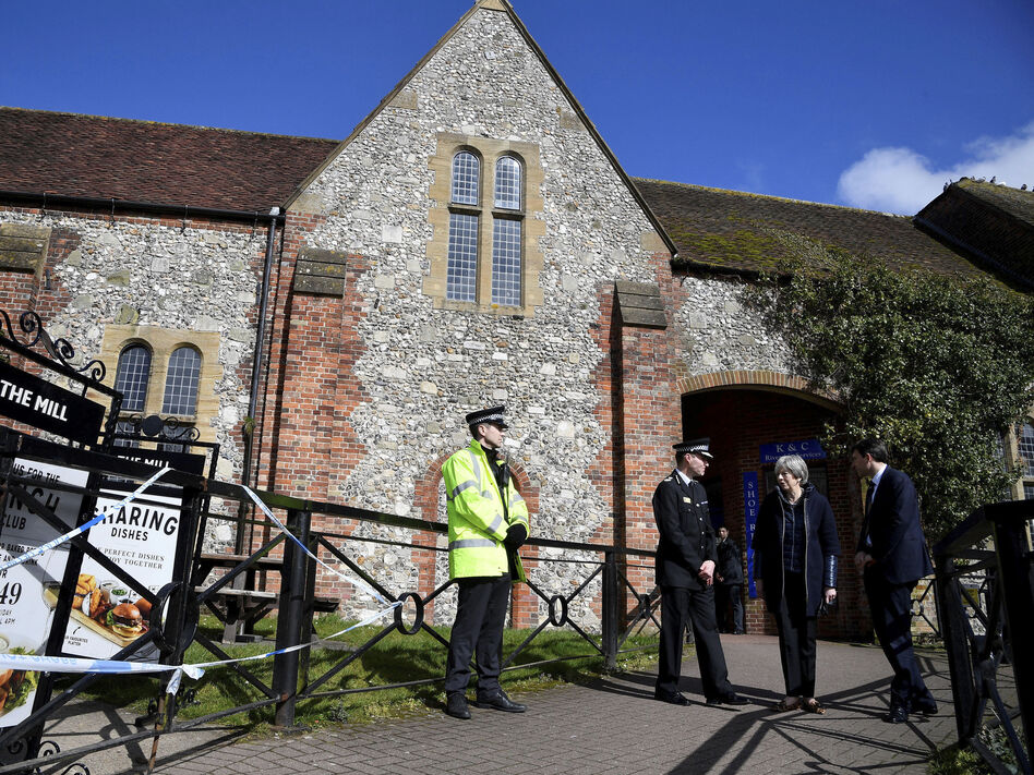 Britain's Prime Minister Theresa May stands outside a pub as she views the area where former Russian double agent Sergei Skripal and his daughter were found critically ill in March. (Toby Melville/AP)