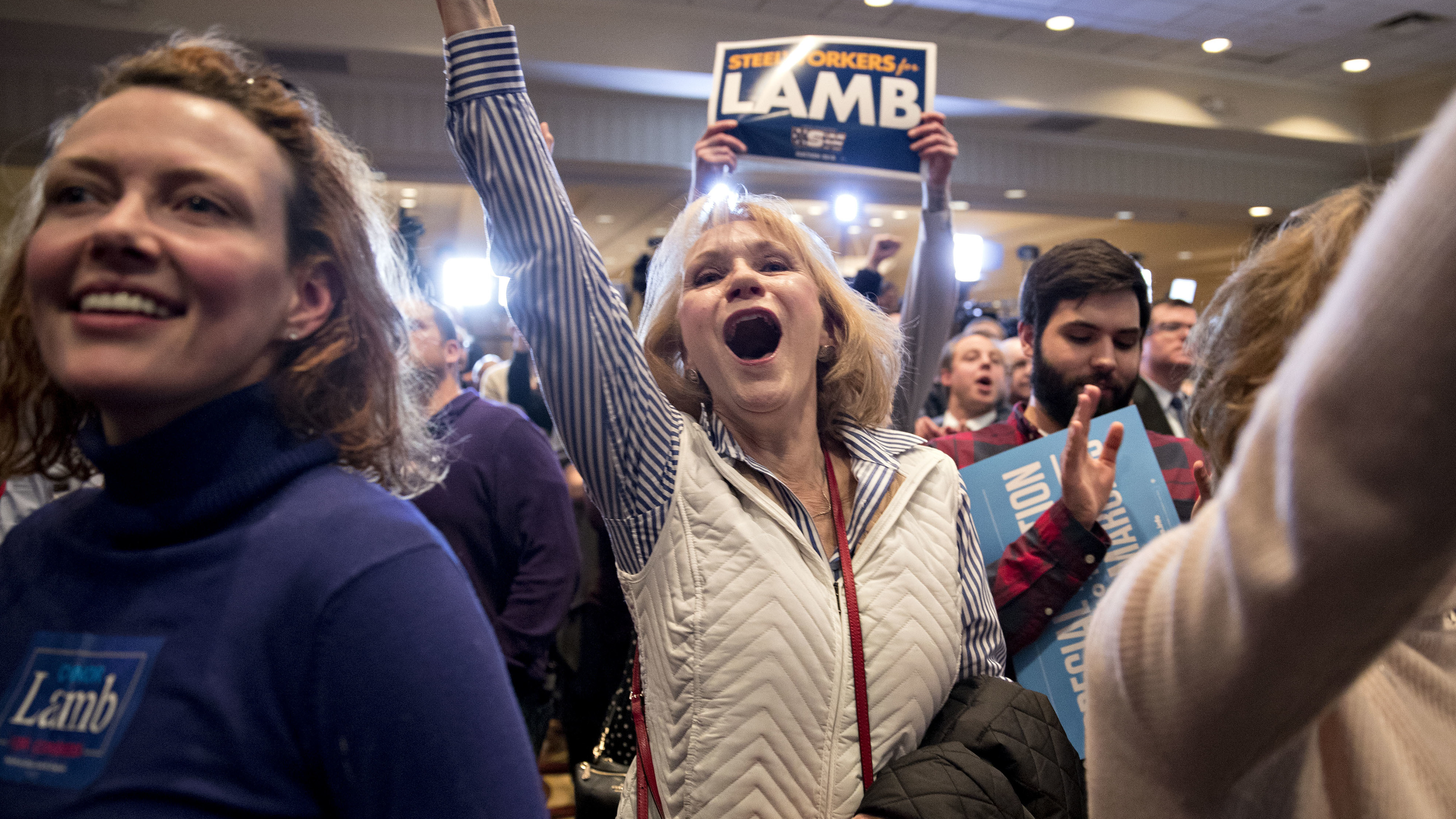 Supporters cheer at an election night rally in Canonsburg, Pa., for Democrat Conor Lamb, whose victory got a boost from suburban voters. (Bloomberg via Getty Images)