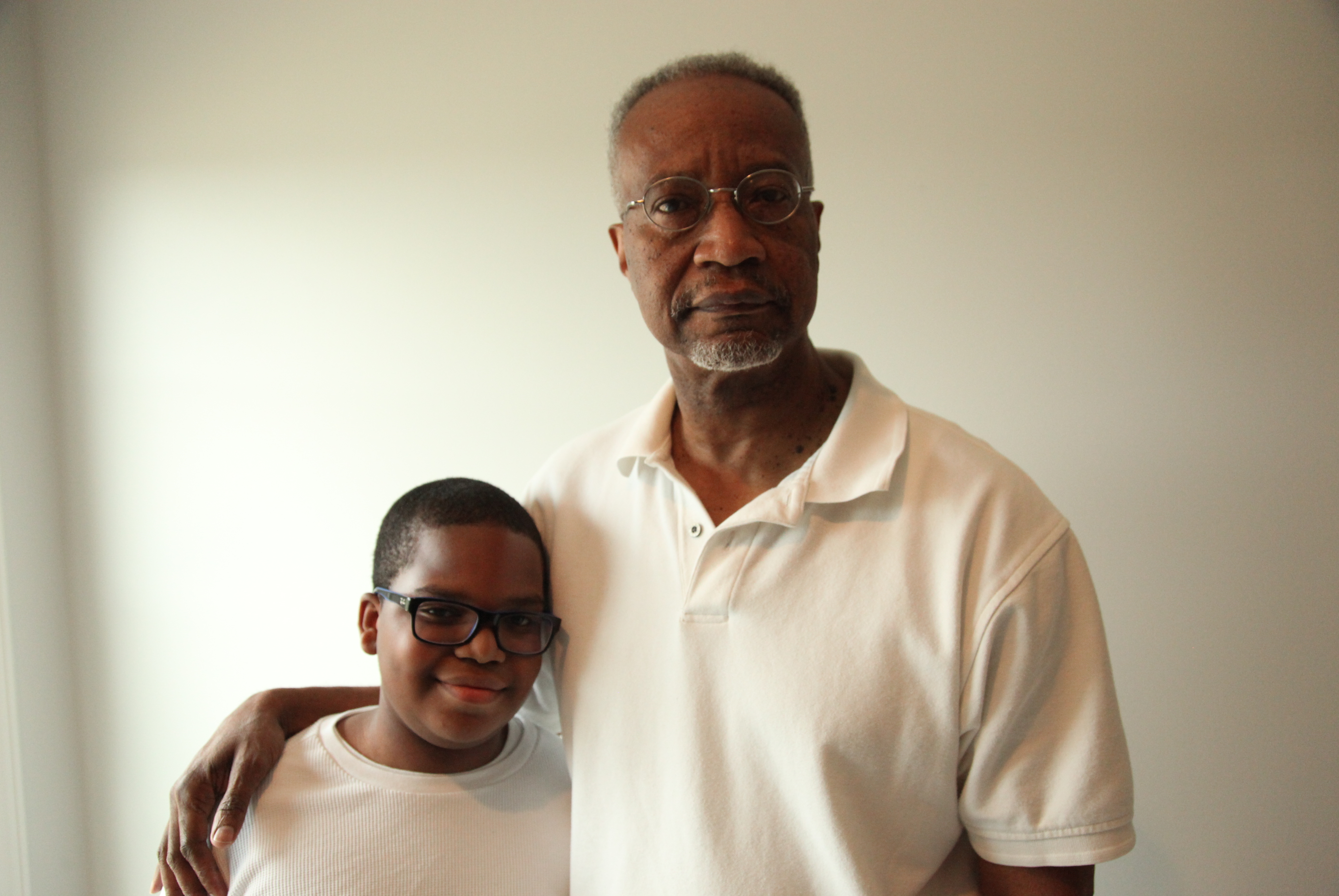 Robert Tunstall with his grandson James Hartridge, both from Memphis. Tunstall is a retired airways systems' specialist with the Federal Aviation Administration, where he worked for 39 years. (Jeffrey Pierre for NPR)