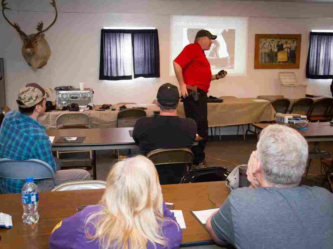 Parishioners of the Lighthouse Mexico Church of God listen as Cory Monroe, a firearms instructor, speaks on how to carry a concealed weapon.