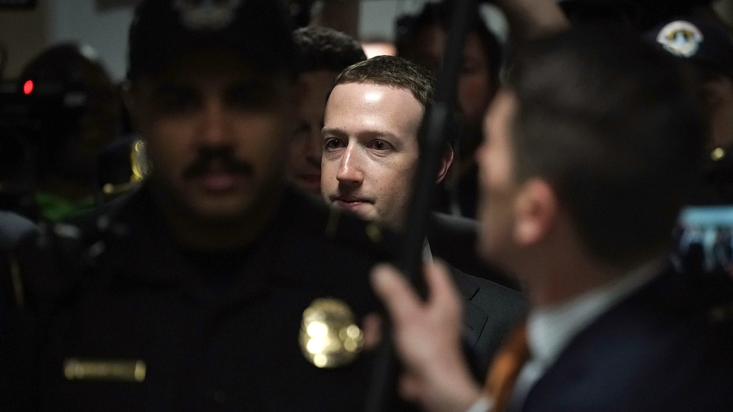 Facebook CEO Mark Zuckerberg is escorted by police on his way to a meeting Monday with U.S. Sen. Dianne Feinstein, D-Calif., ranking member of the Senate Judiciary Committee. (Getty Images)