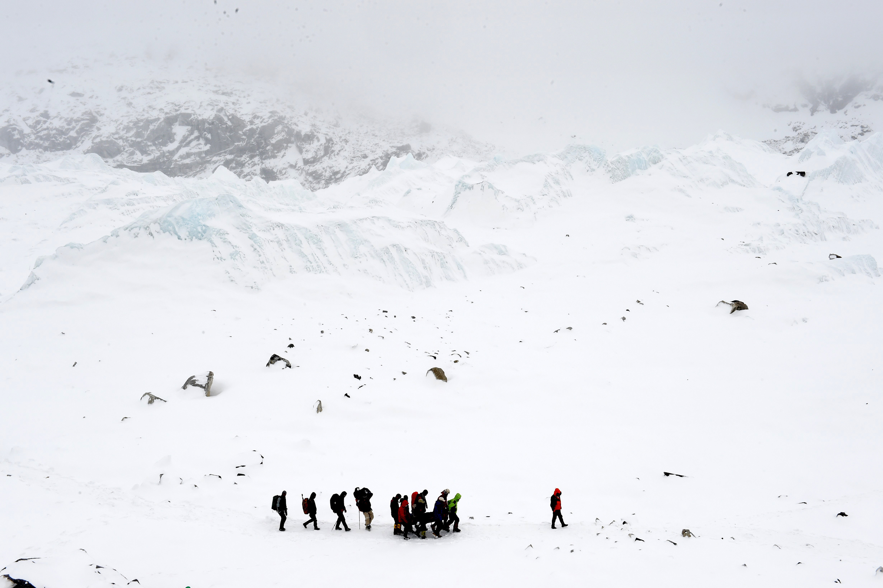 Rescuers carry a Sherpa injured by an avalanche that flattened parts of Everest Base Camp on April 25, 2015. A 7.8 magnitude earthquake hit Nepal and took at least 17 lives at Everest Base Camp, including seven Sherpas. (AFP/Getty Images)