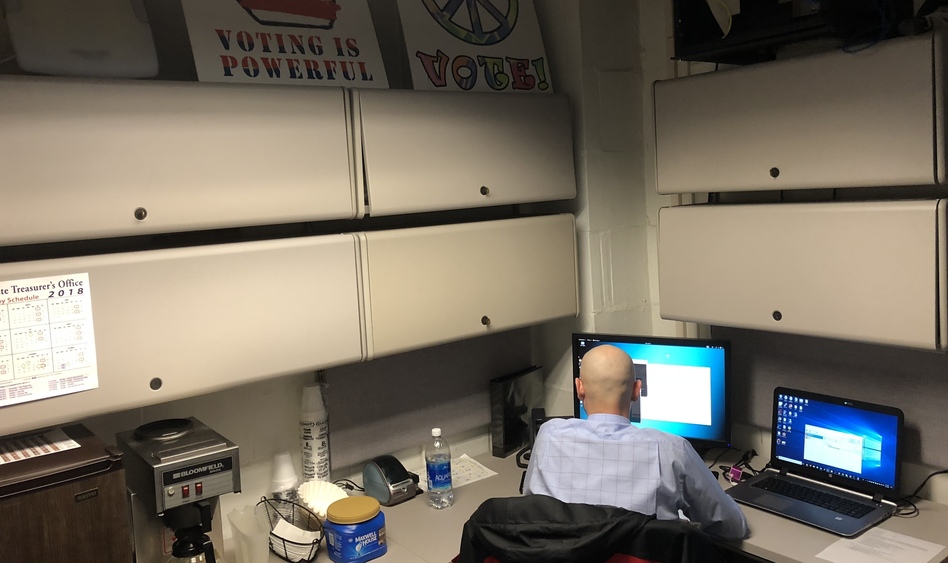 A member of the West Virginia National Guard works in the basement of the state Capitol in Charleston, W.Va., on secondment to the Secretary of State's office to work on cybersecurity around state elections. (Dave Mistich/West Virginia Public Broadcasting)