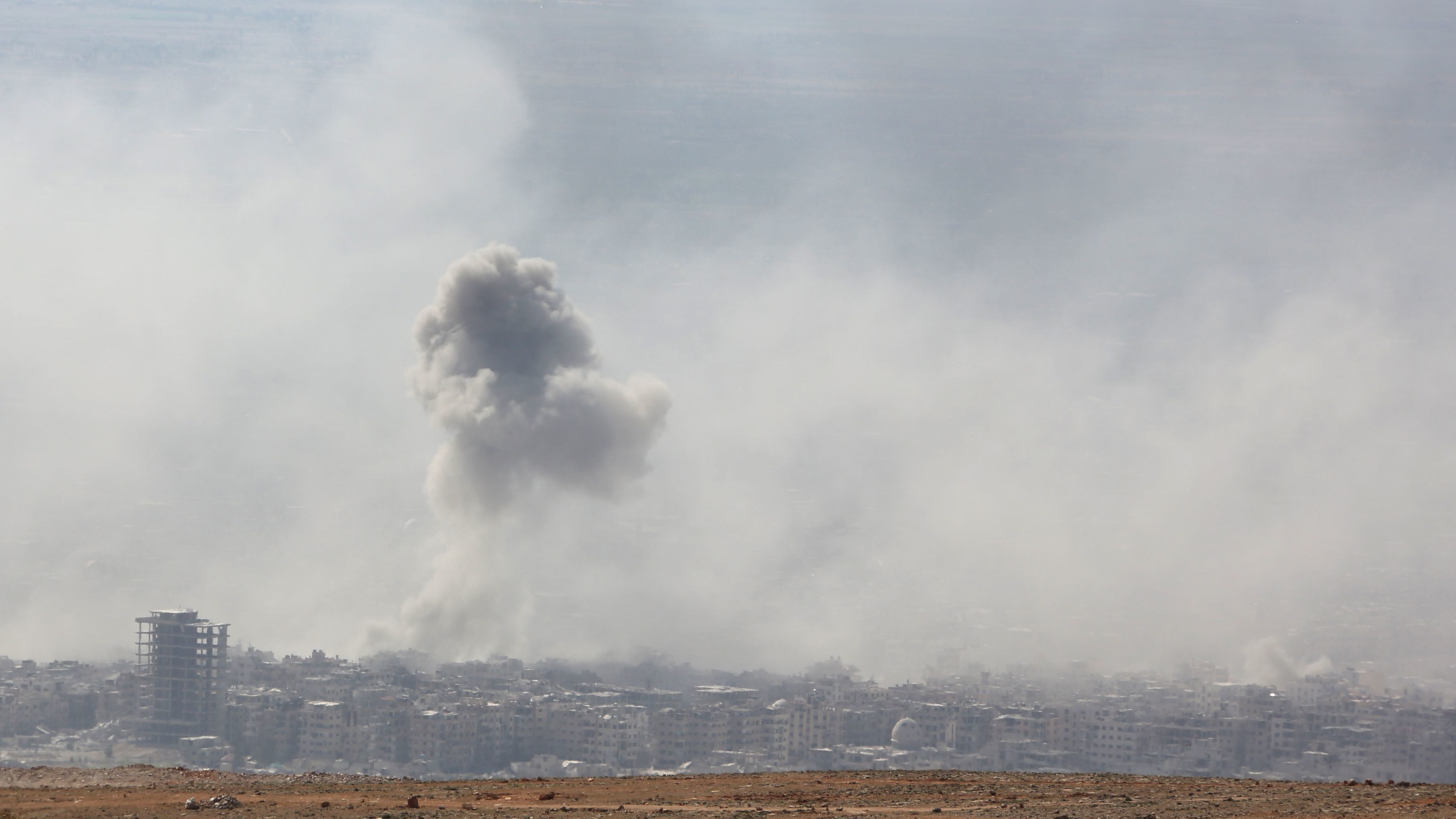 Smoke billows above Douma, Syria, on Saturday. The White House says President Trump is weighing military action following an alleged chemical attack in the town. (AFP/Getty Images)