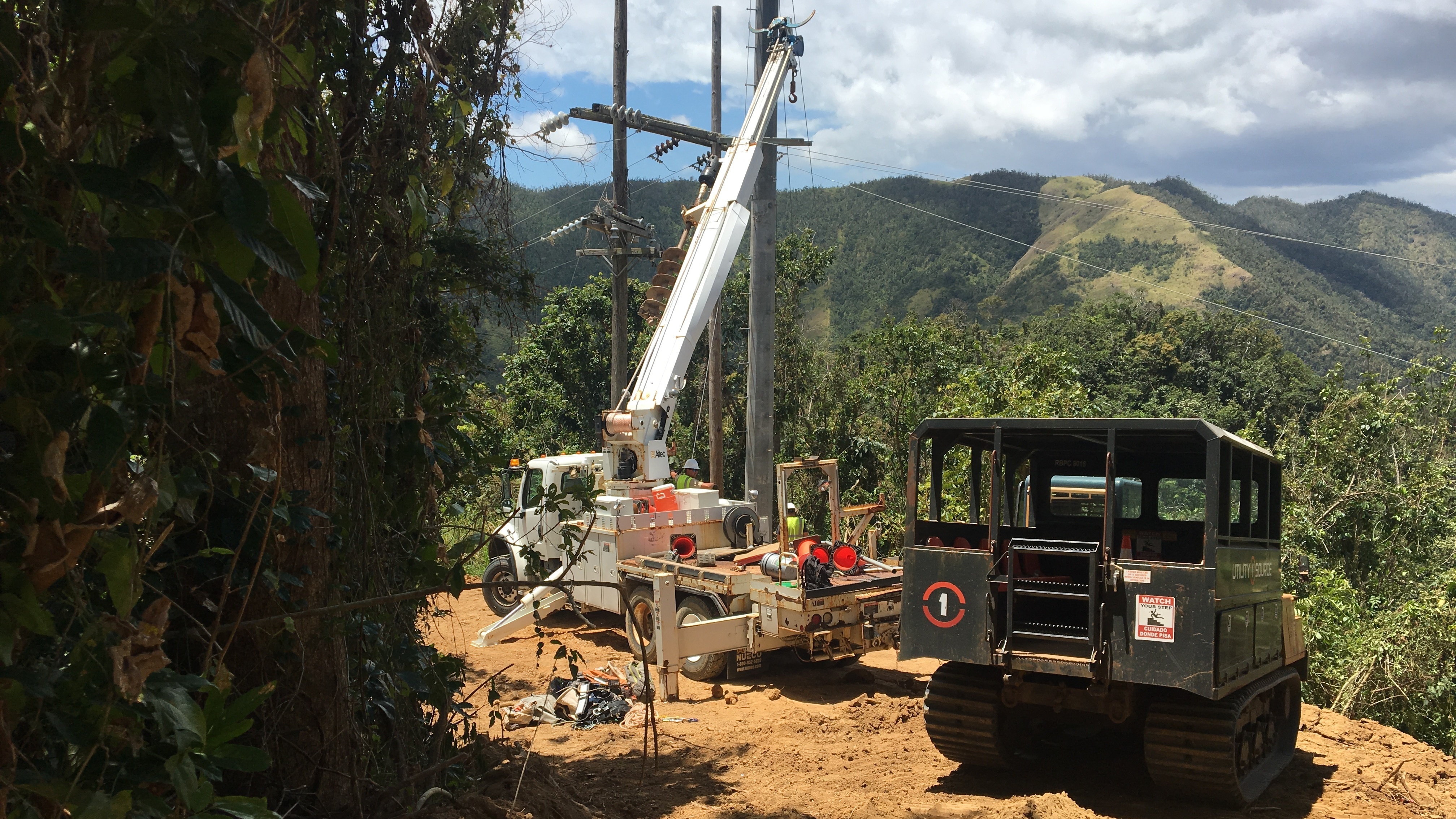 Contractors working to restore power in Cayey, Puerto Rico, last week, the same region where a falling tree interrupted a main transmission line Thursday, plunging 840,000 customers into darkness. (NPR)