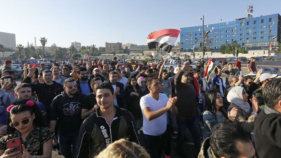 Syrians condemn the U.S.-led airstrikes, at a protest Saturday at the Omayyad Square in Damascus. (Louai Beshara/AFP/Getty Images)